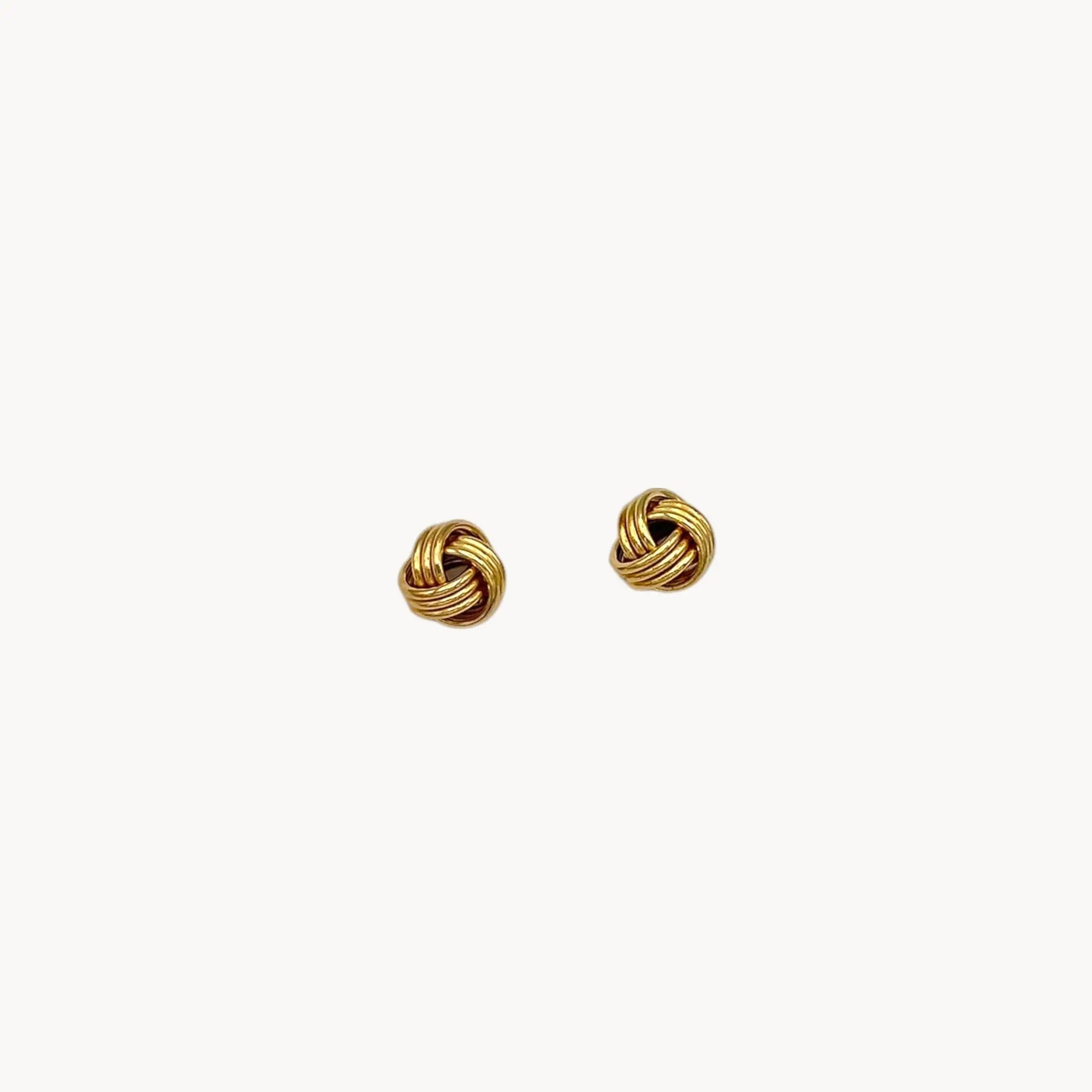 10K yellow gold knot stud pierced earrings, classic love knot design on white background. 