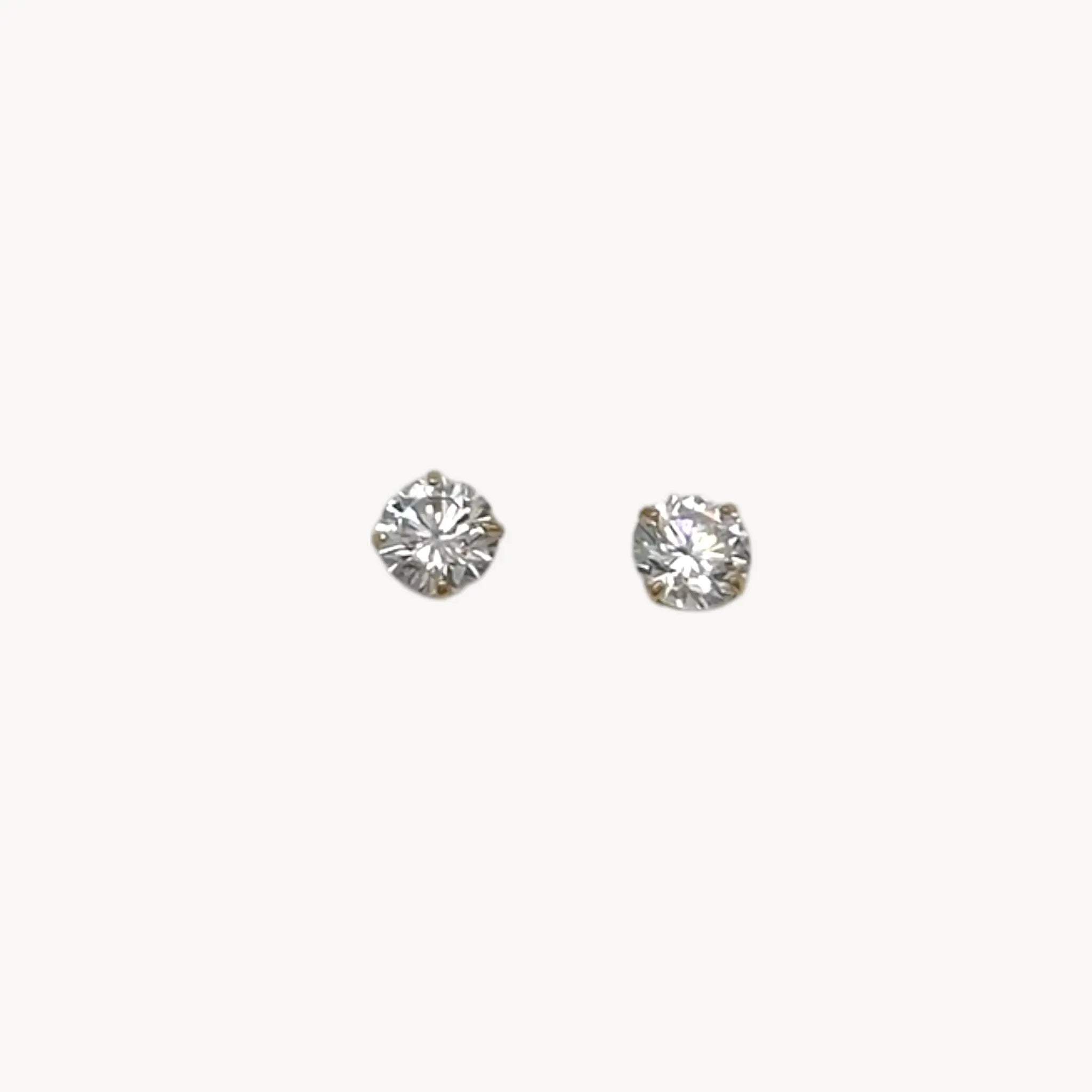14K yellow gold cubic zirconia solitaire stud earrings displayed on white background.