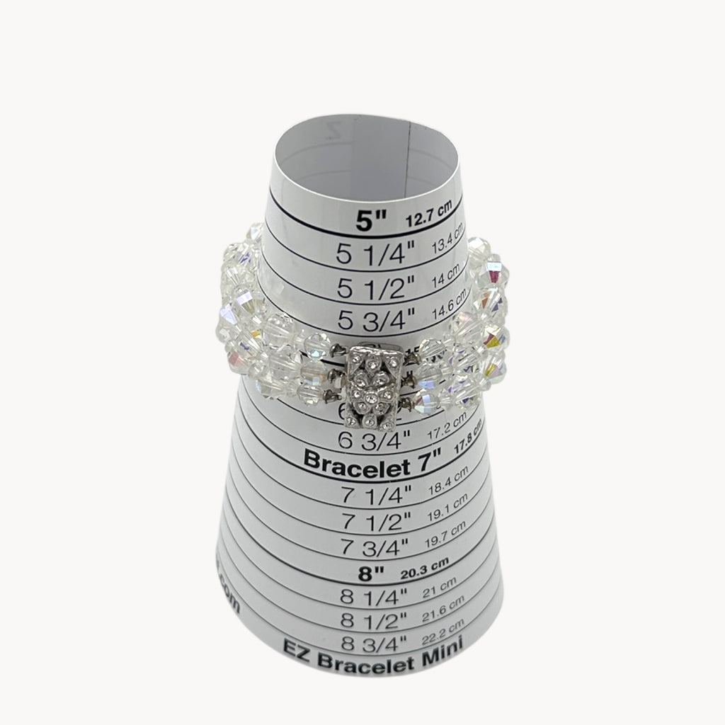 On sizer view of Vintage unsigned multi-strand faceted crystal bracelet with rhinestone clasp in Art Deco style.