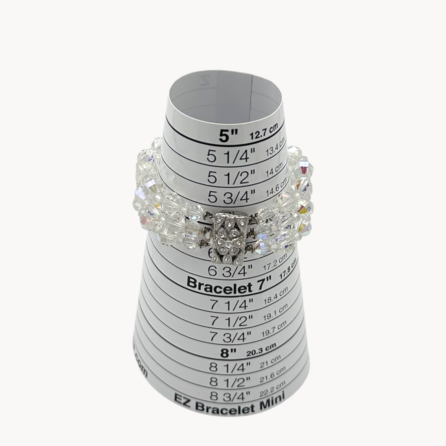 On sizer view of Vintage unsigned multi-strand faceted crystal bracelet with rhinestone clasp in Art Deco style.
