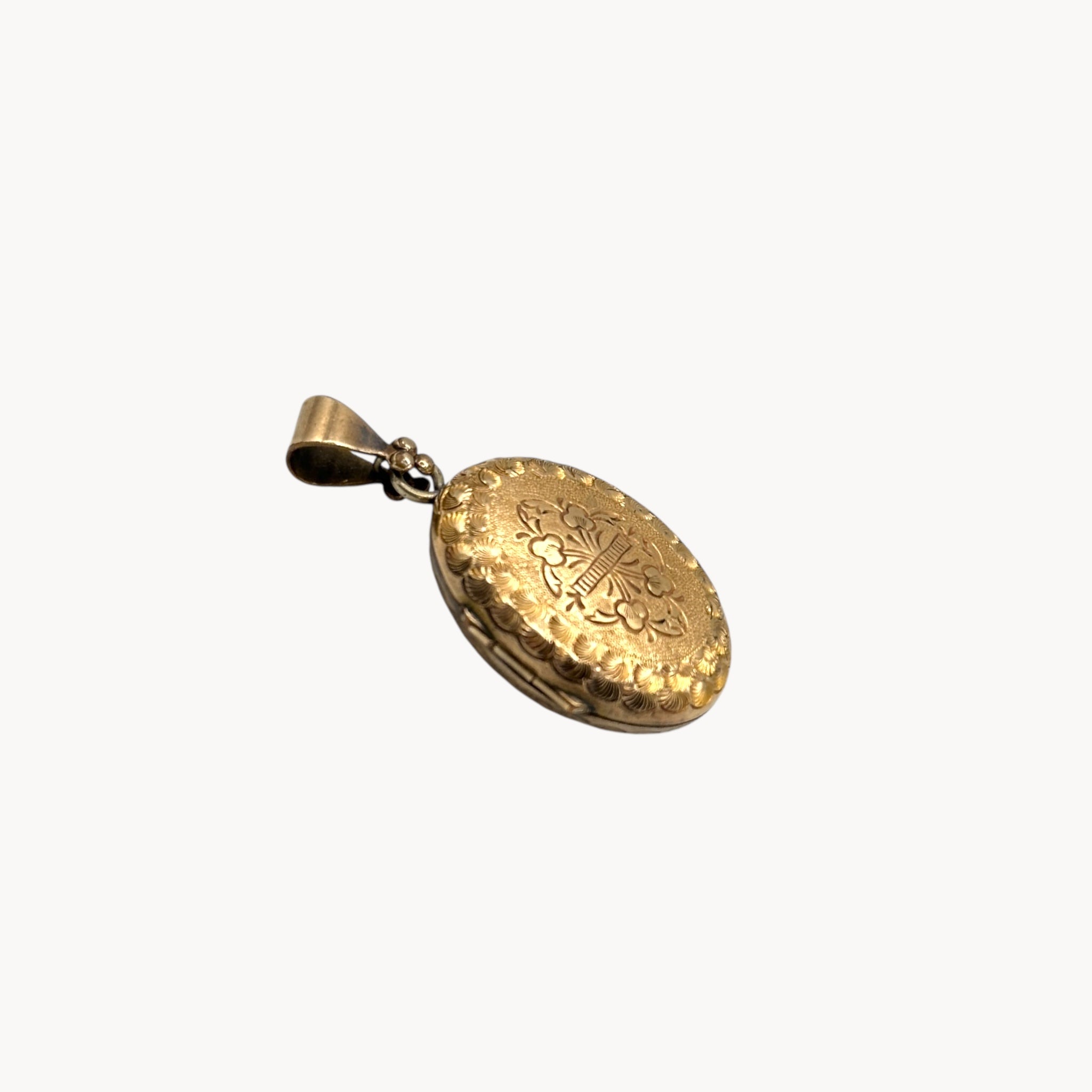 Side view Antique gold-filled etched floral locket with ornate border, Victorian keepsake pendant.