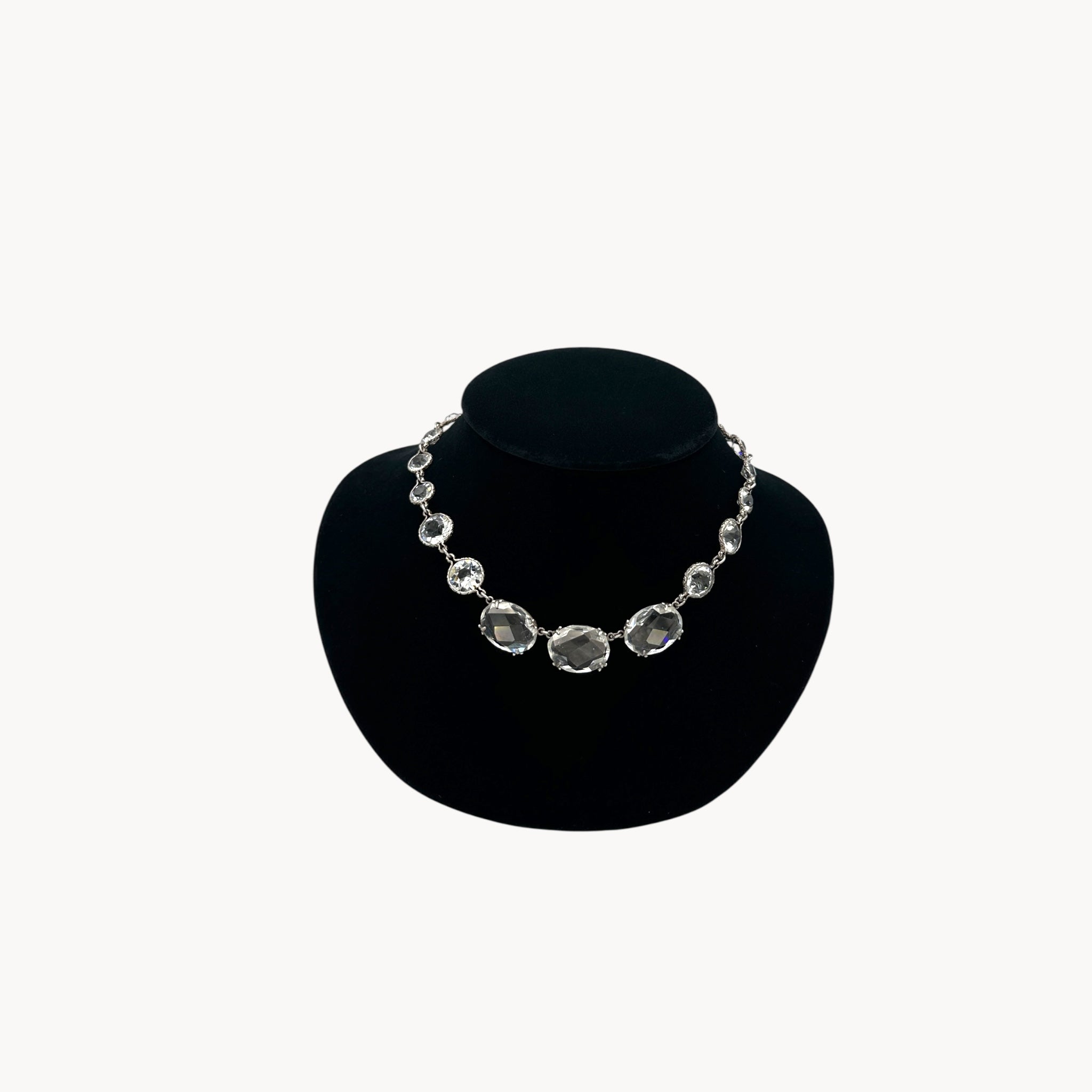 Vintage Art Deco crystal necklace with round and oval-cut crystals stones on black bust.