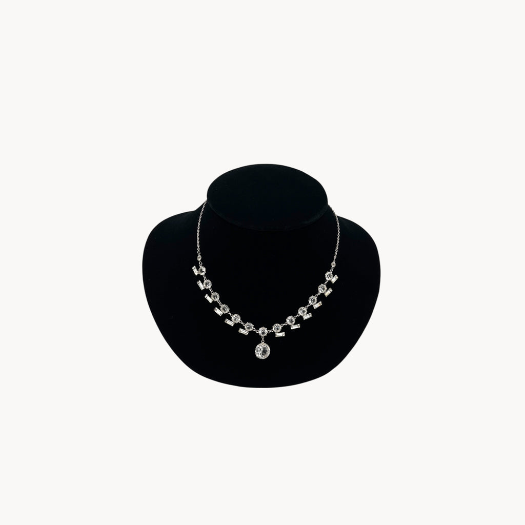 Art Deco sterling silver clear crystal necklace with geometric design and round drop.