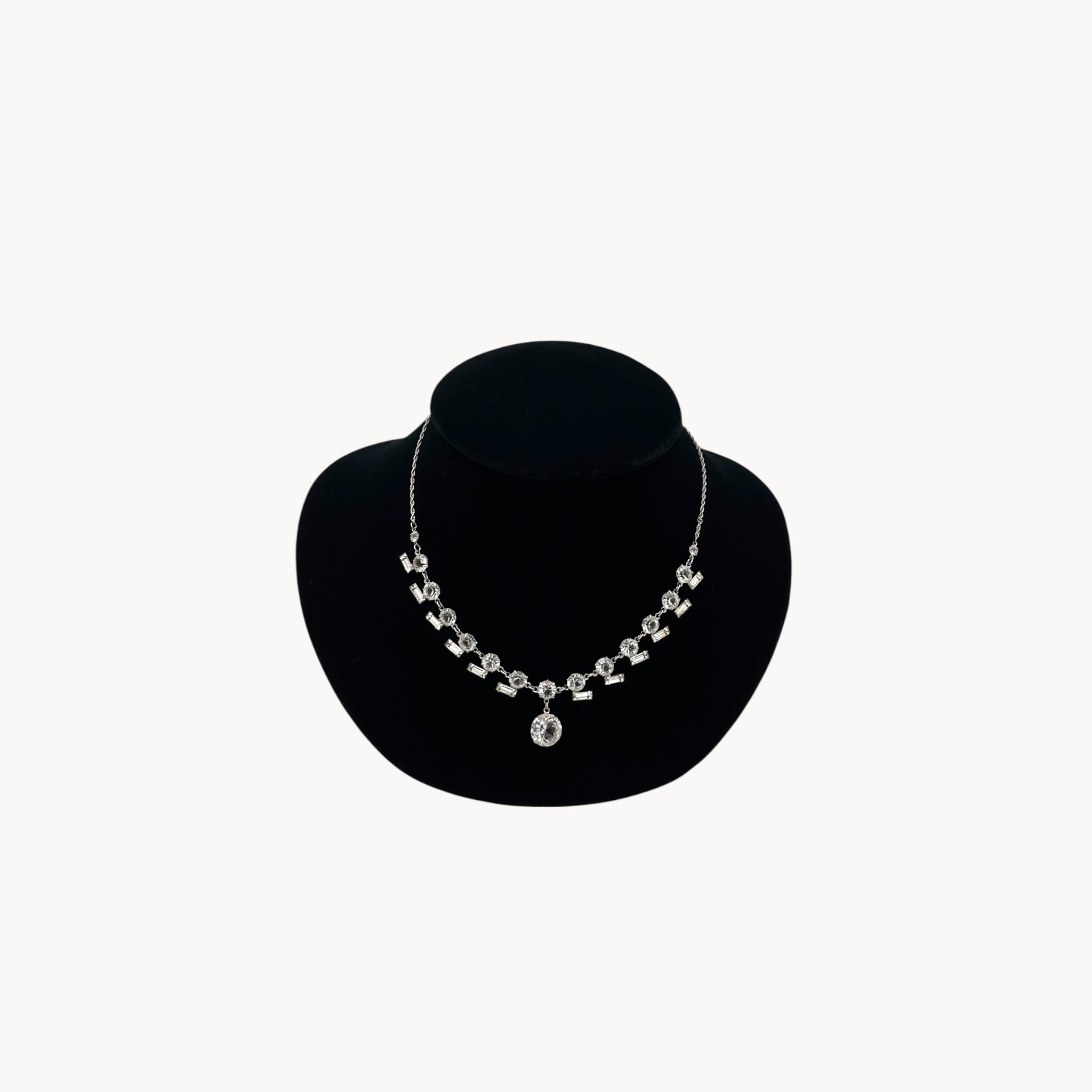 Art Deco sterling silver clear crystal necklace with geometric design and round drop.