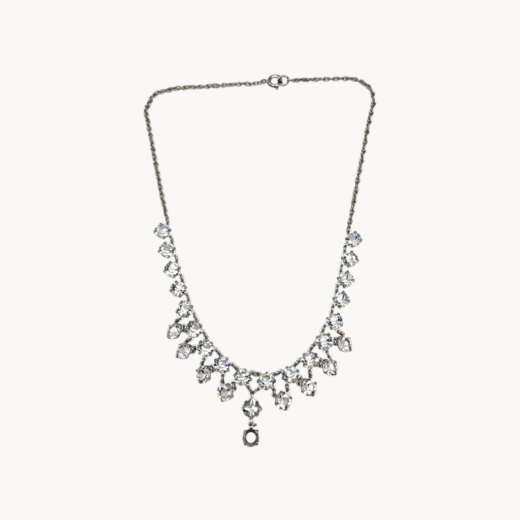 Art Deco style rhodium plated crystal fringe necklace on white background.