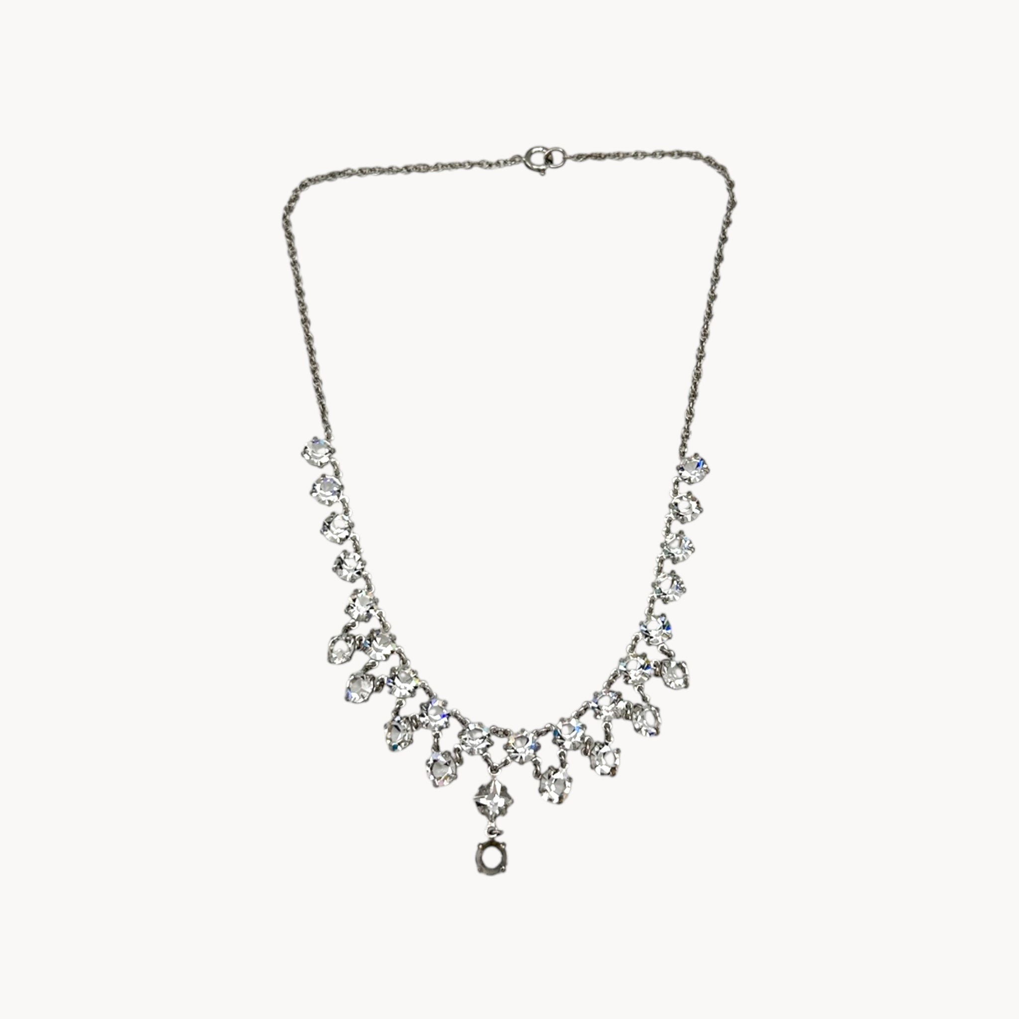 Art Deco style rhodium plated crystal fringe necklace on white background.