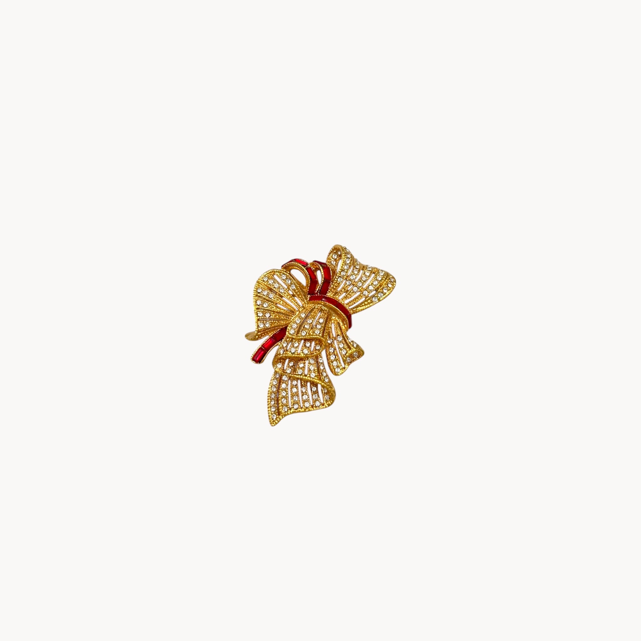 Jacqueline Bouvier Kennedy Camrose & Kross gold bow brooch with crystals and red rhinestones.