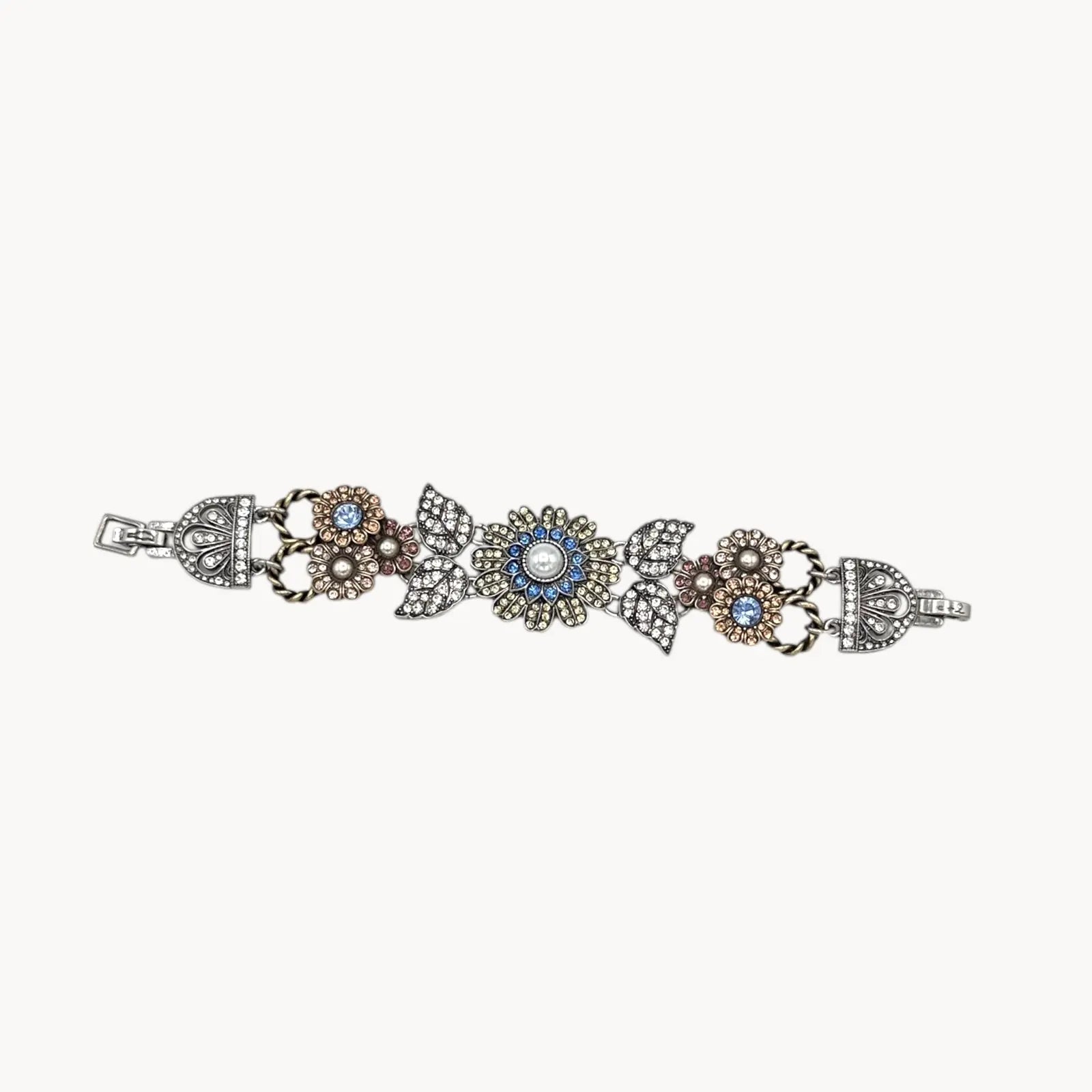 Chloe + Isabel multi-color floral rhinestone bracelet with pearls and crystal leaves on white background.
