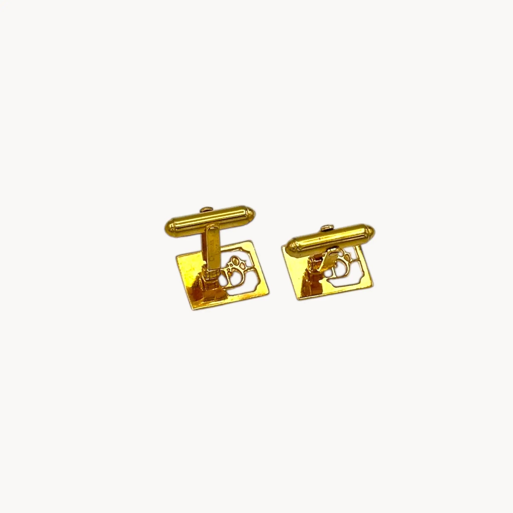 Back view of Vintage Christian Dior gold-plated square cufflinks with logo cutout design displayed on white background.
