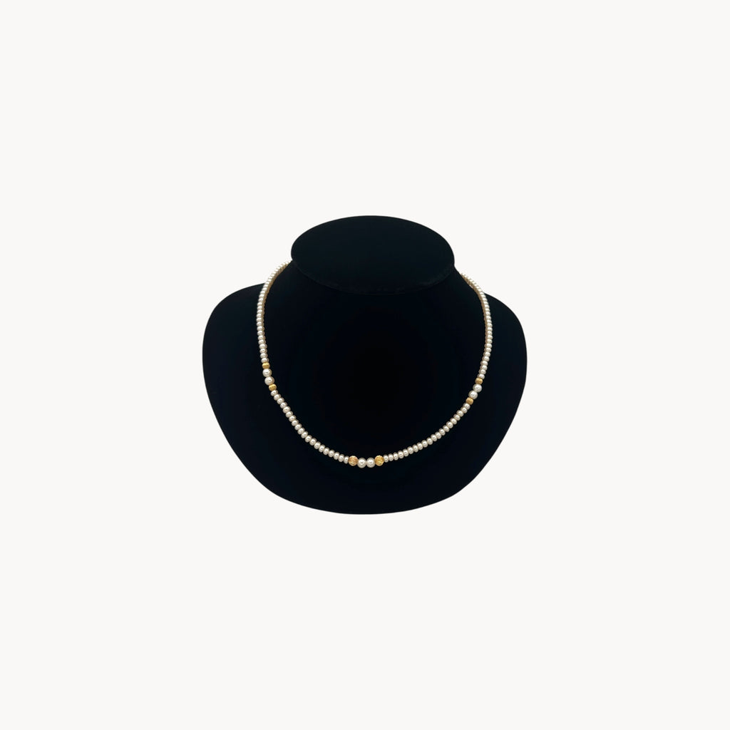 Classic pearl and 14K gold bead strand necklace, vintage fine jewelry on black bust.