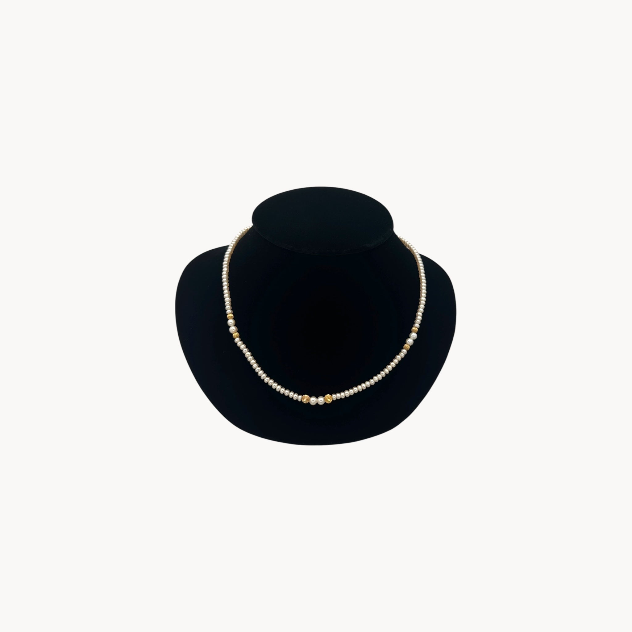 Classic pearl and 14K gold bead strand necklace, vintage fine jewelry on black bust.
