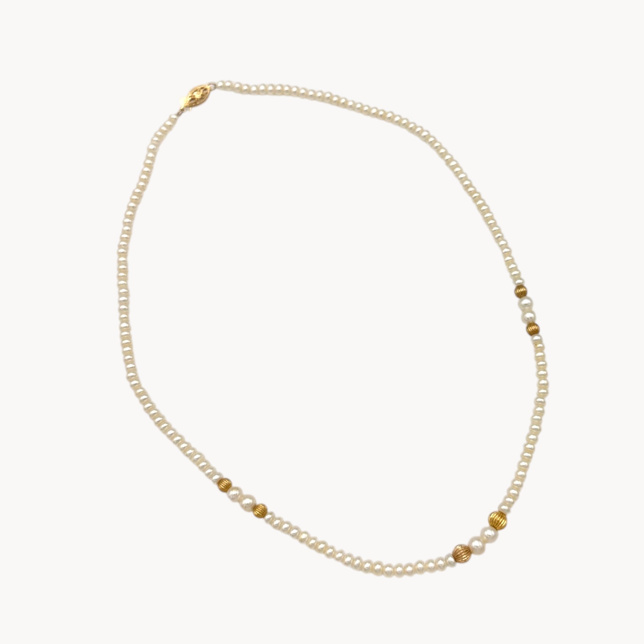 Classic pearl and 14K gold bead strand necklace, vintage fine jewelry on white background.