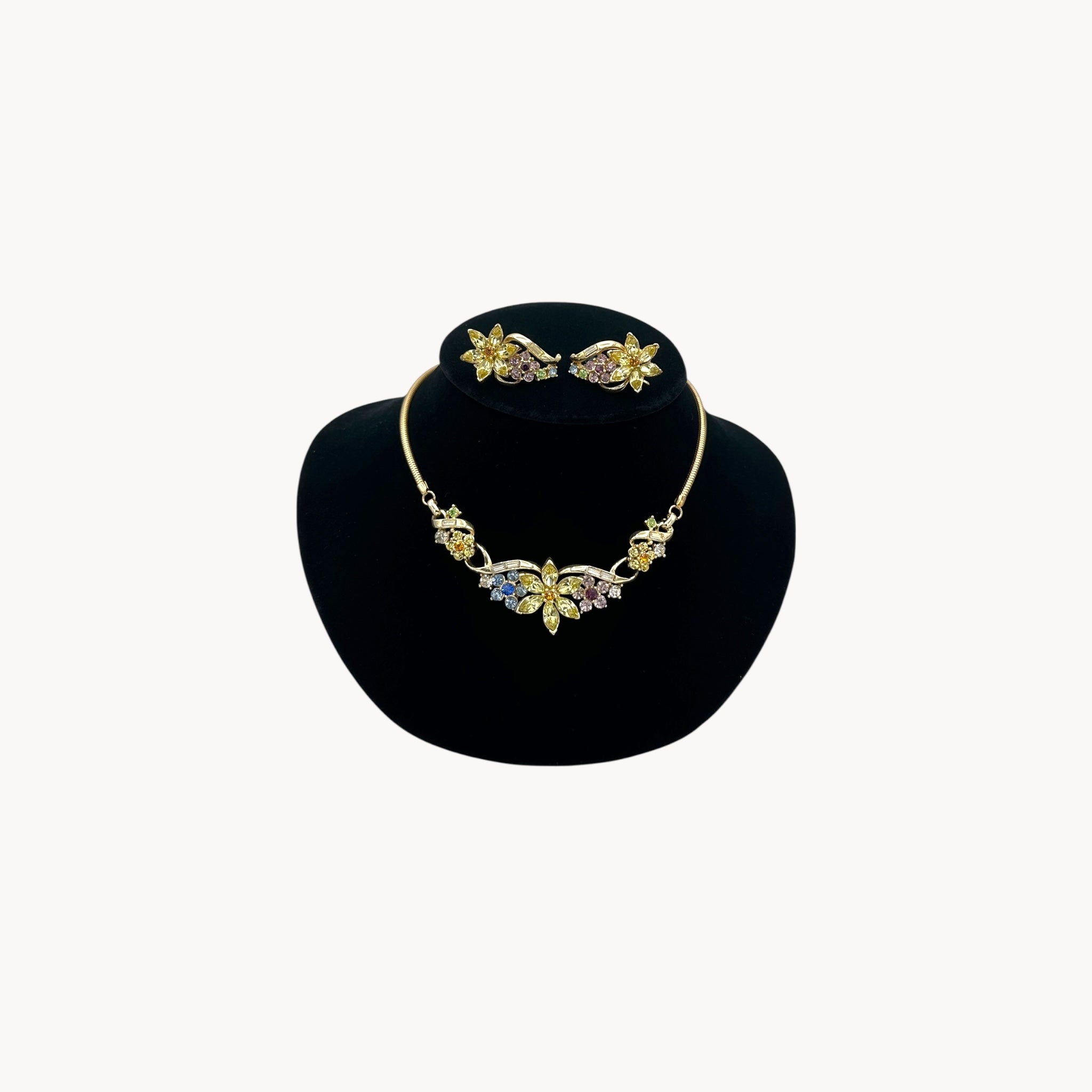Vintage Coro multi-color rhinestone necklace and clip-on earring set with floral design.