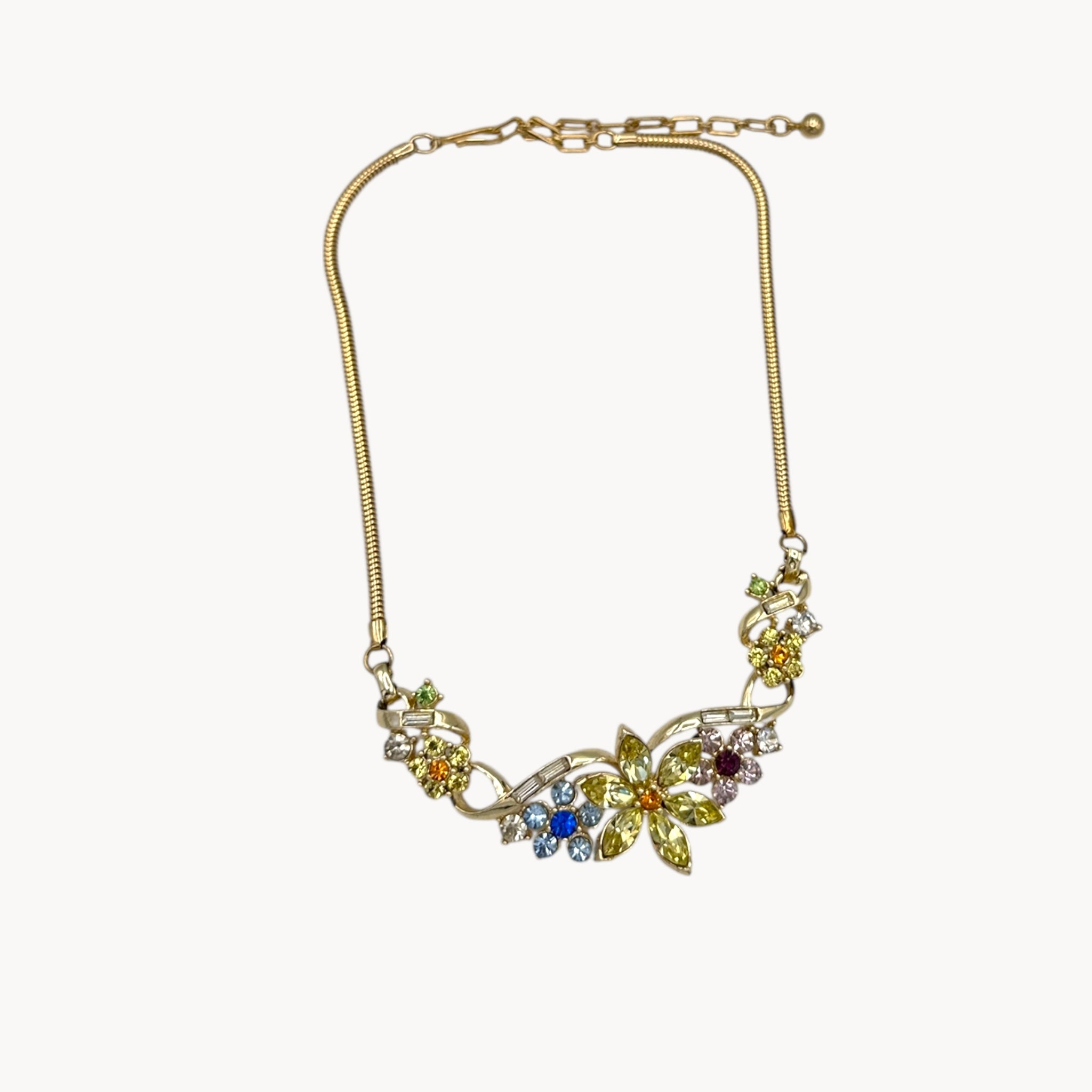Necklace against white background of Vintage Coro multi-color rhinestone necklace and clip-on earring set with floral design