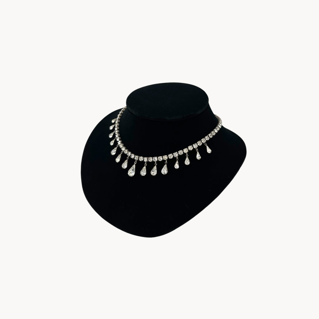 Side view of Coro sterling silver Art Deco necklace with teardrop rhinestone pendant.