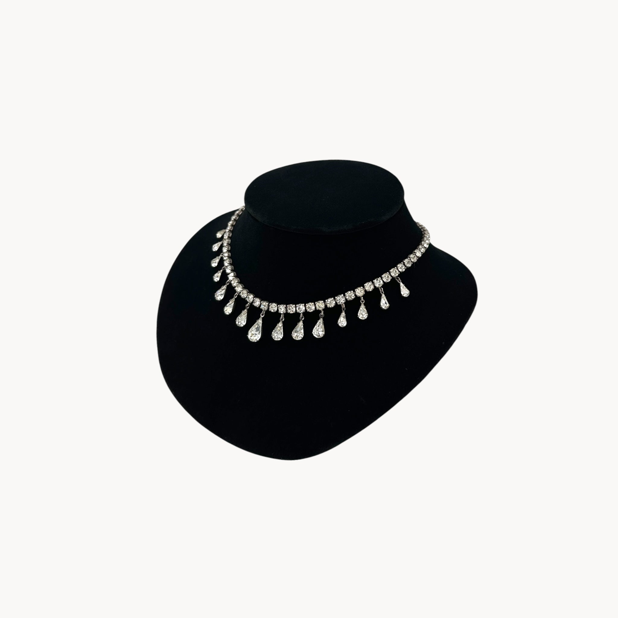 Side view of Coro sterling silver Art Deco necklace with teardrop rhinestone pendant.