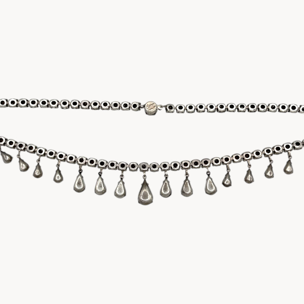 Back view of Coro sterling silver Art Deco necklace with teardrop rhinestone pendant on white background.