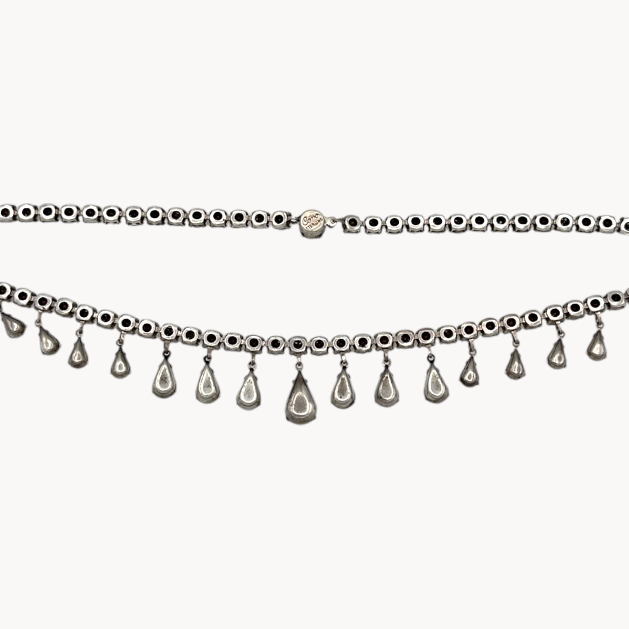 Back view of Coro sterling silver Art Deco necklace with teardrop rhinestone pendant on white background.
