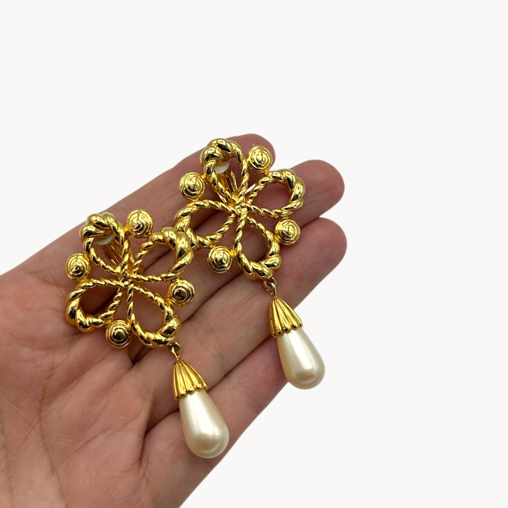Scale size view Vintage Joan Rivers clip-on earrings with gold filigree design and faux pearl drops, 1990s bridal jewelry.