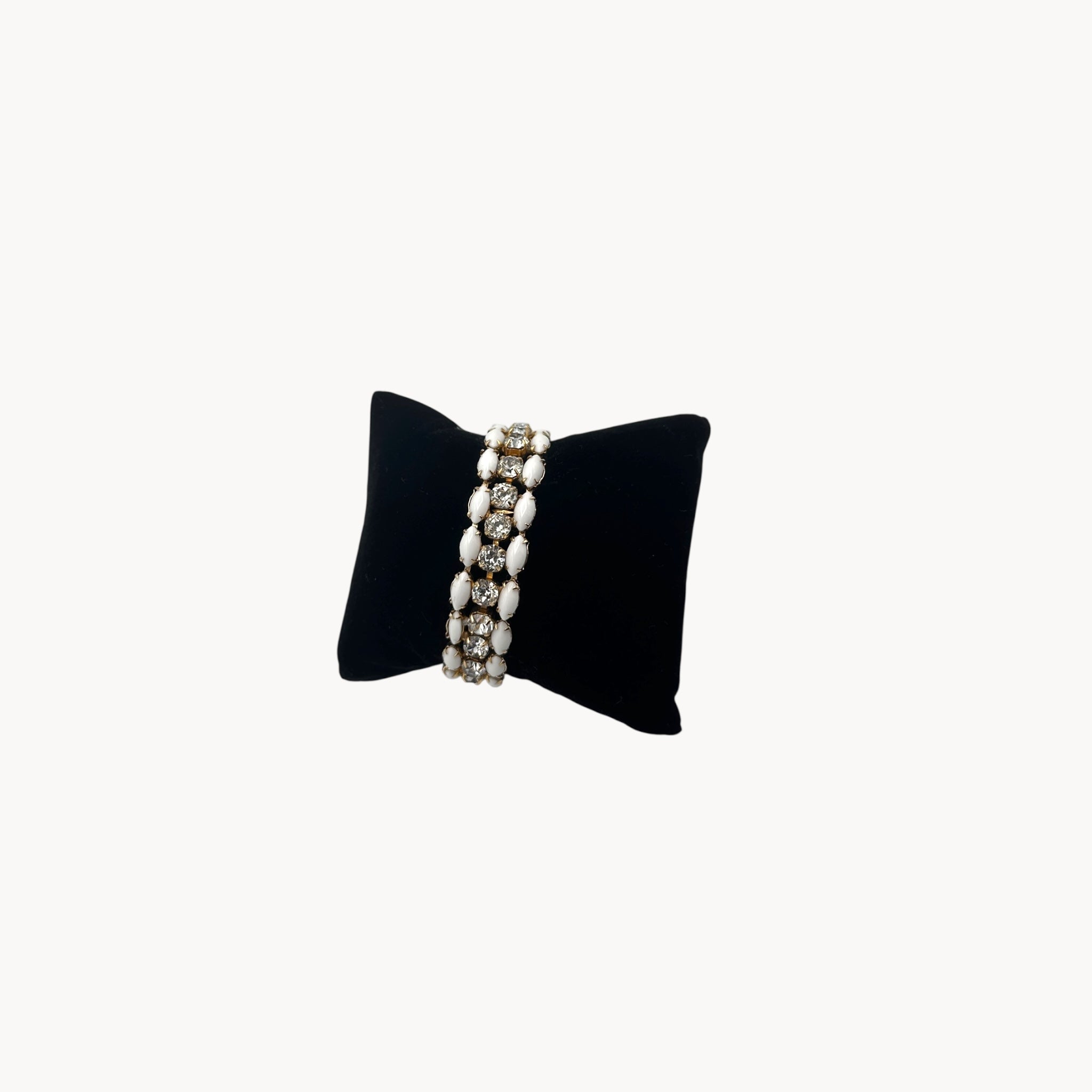 Side view of Mid-century Eisenberg bracelet with white milk glass and rhinestones, double-row design.