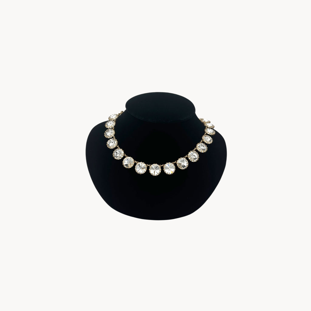 J. Crew Venus Flytrap necklace with large clear round rhinestones on black bust.