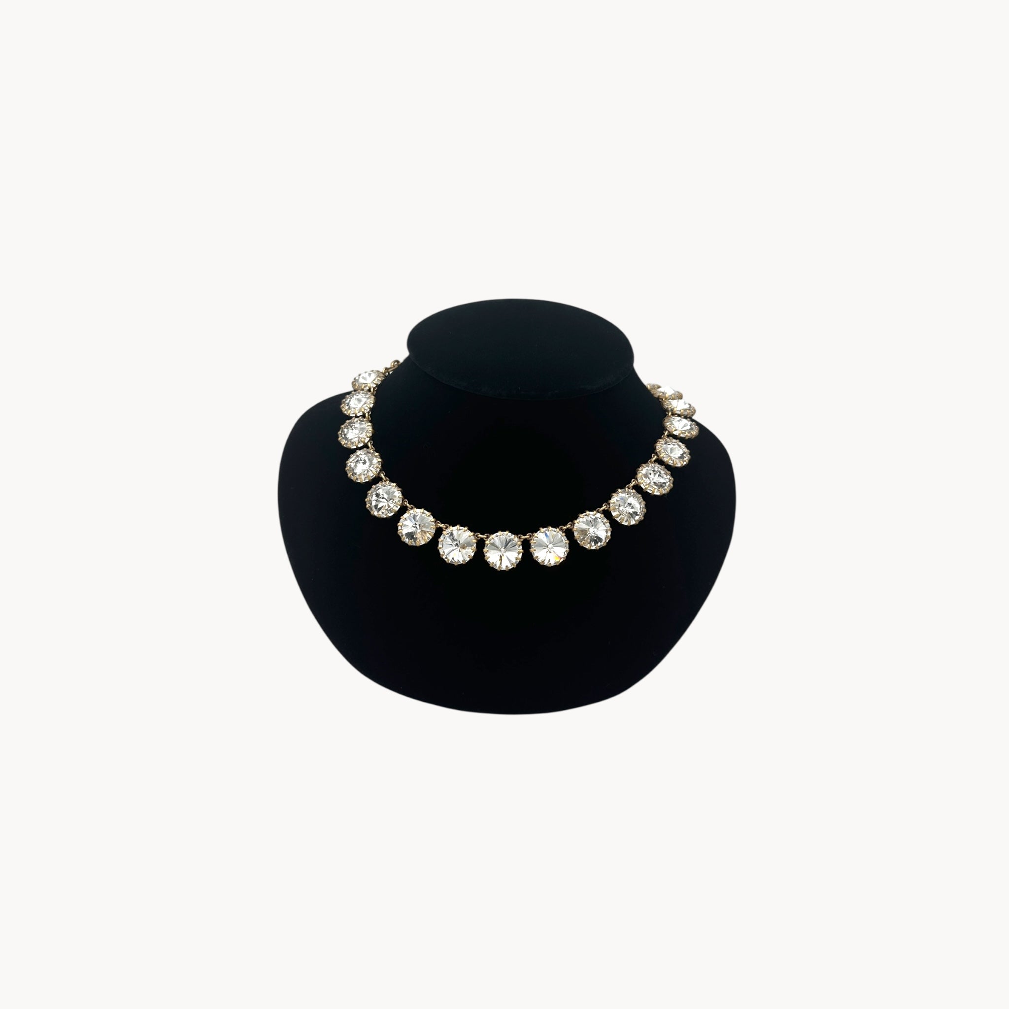 J. Crew Venus Flytrap necklace with large clear round rhinestones on black bust.