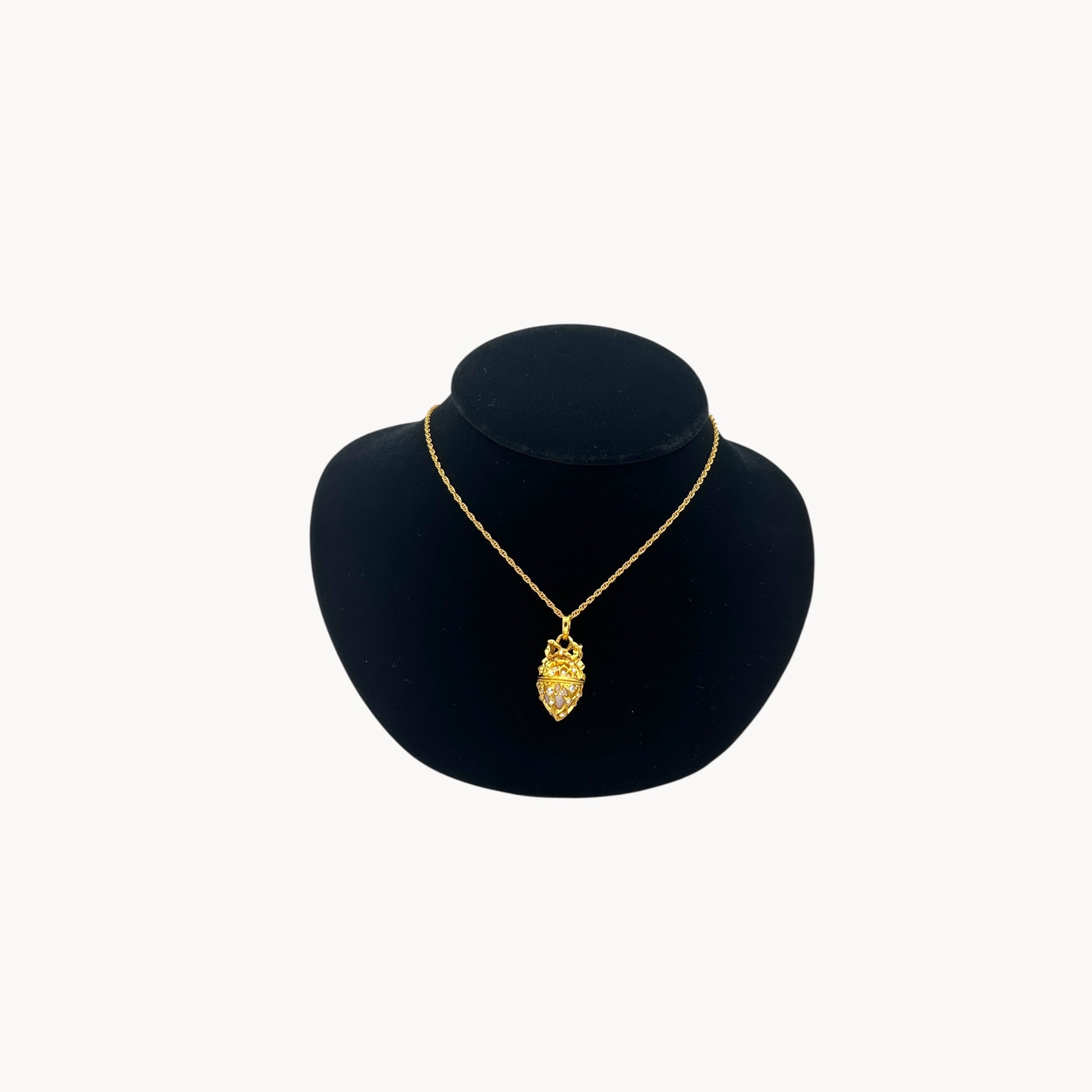 Joan Rivers gold egg locket necklace on long chain