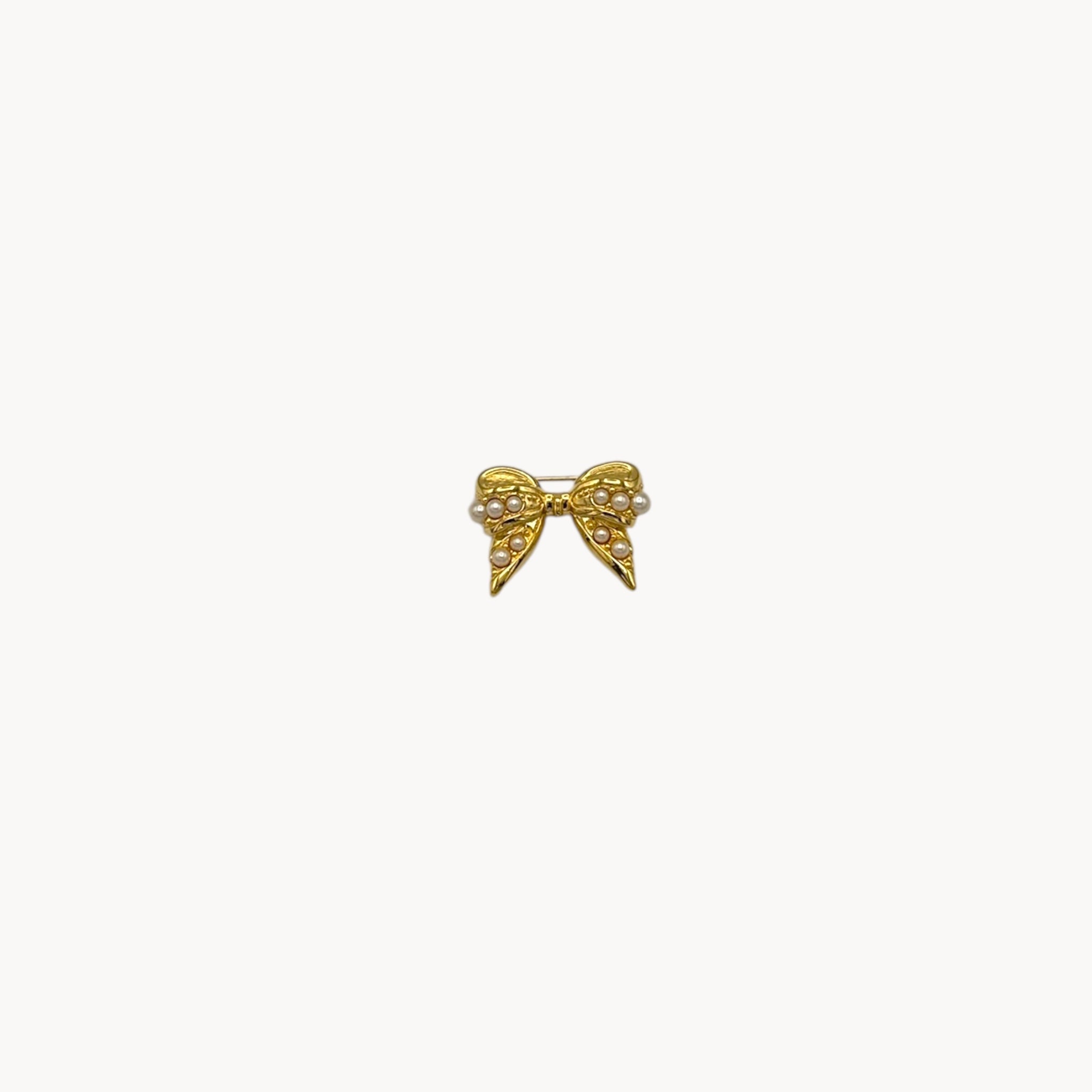 Joan Rivers gold-tone bow brooch with petite faux pearls, vintage jewelry.