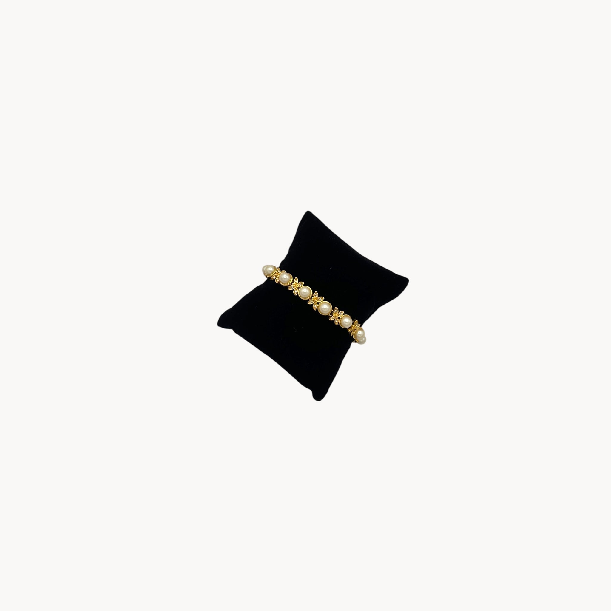 Side view of Joan Rivers gold bracelet with pearls and rhinestones.
