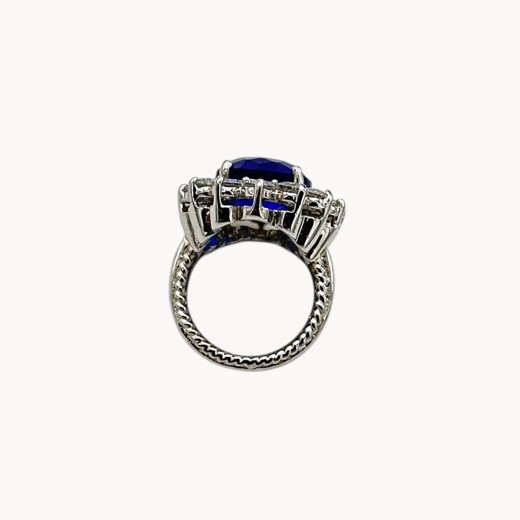 Flat view of Kenneth Jay Lane blue oval crystal cocktail ring inspired by Princess Diana’s sapphire engagement ring on white background.