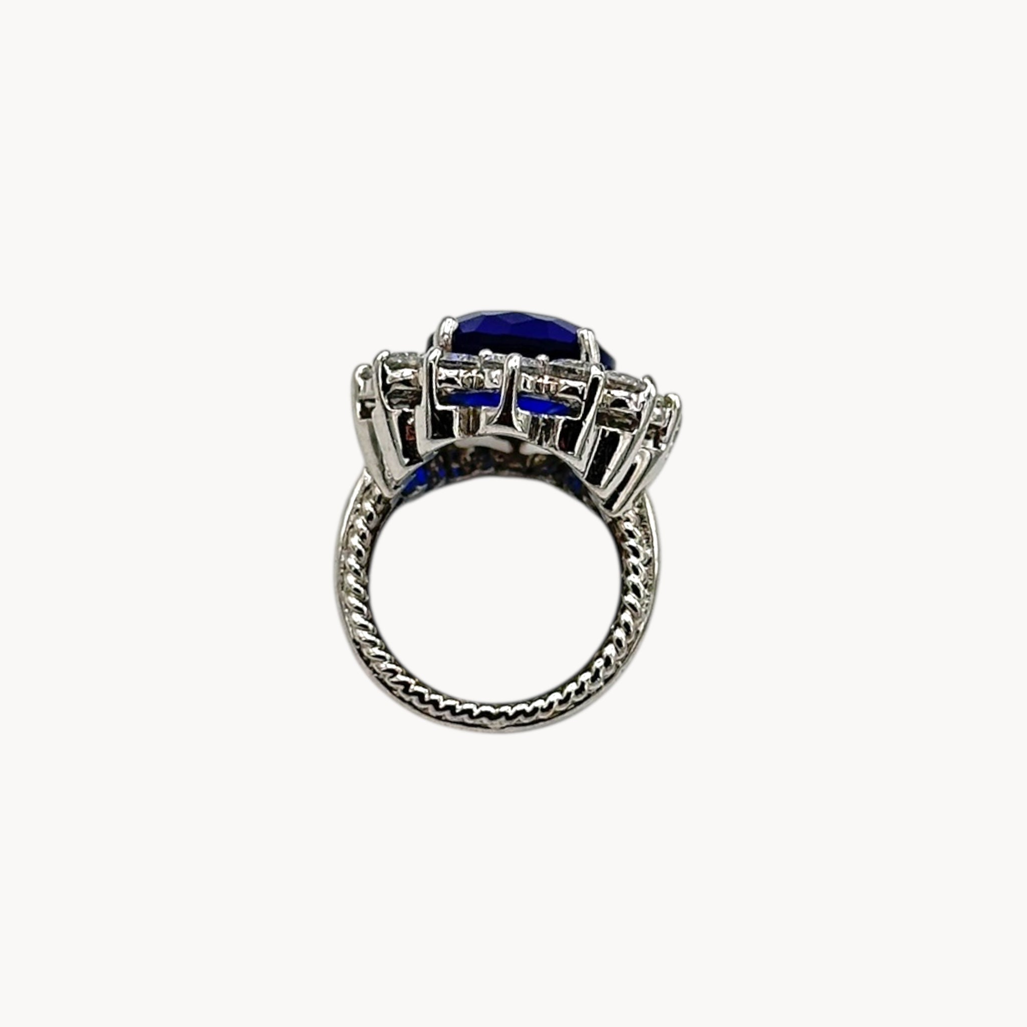 Flat view of Kenneth Jay Lane blue oval crystal cocktail ring inspired by Princess Diana’s sapphire engagement ring on white background.