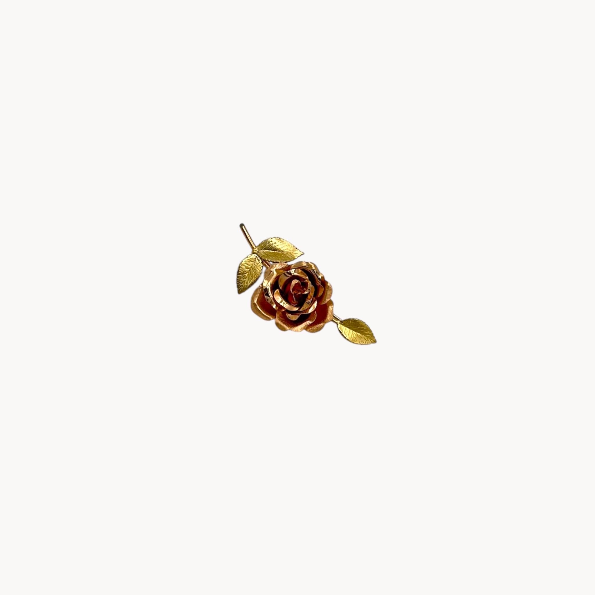 Vintage Krementz gold rose flower brooch with textured leaves.