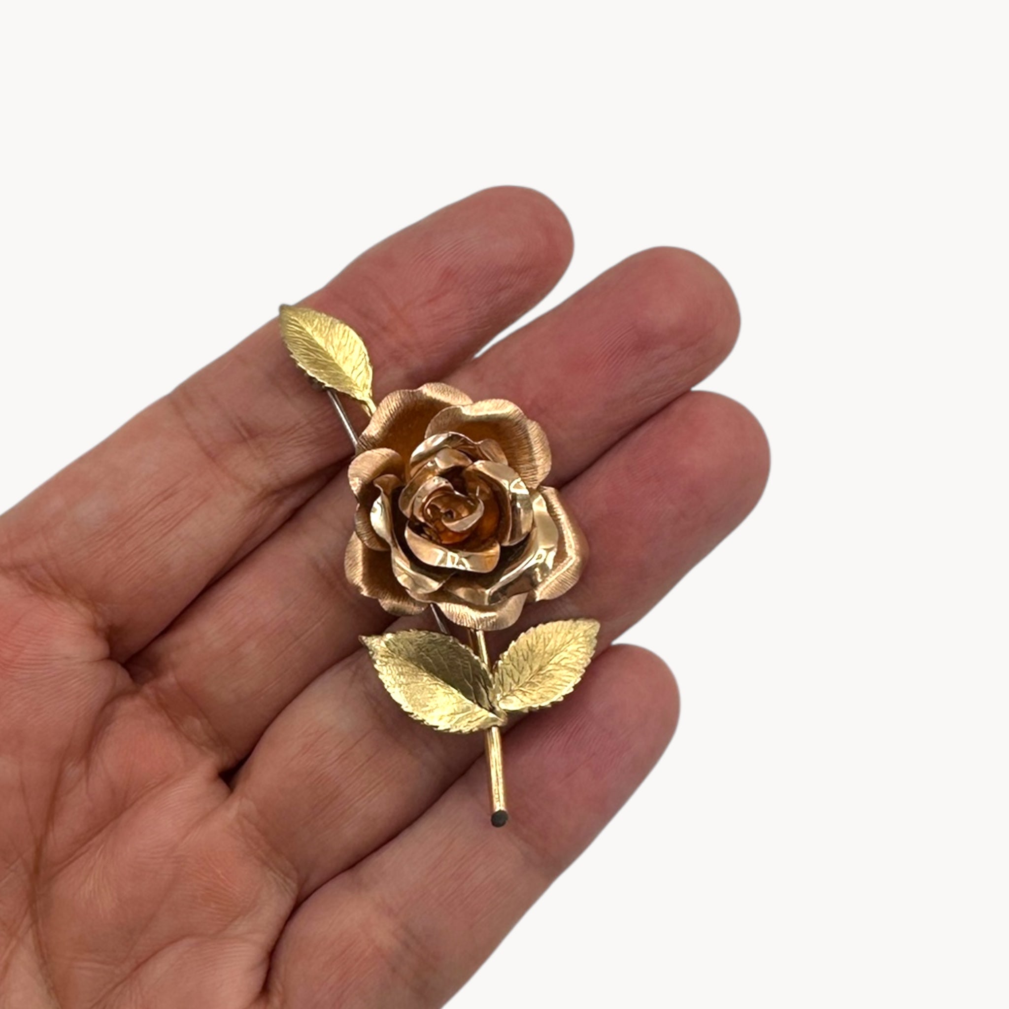 Size scale view of Vintage Krementz gold rose flower brooch with textured leaves.