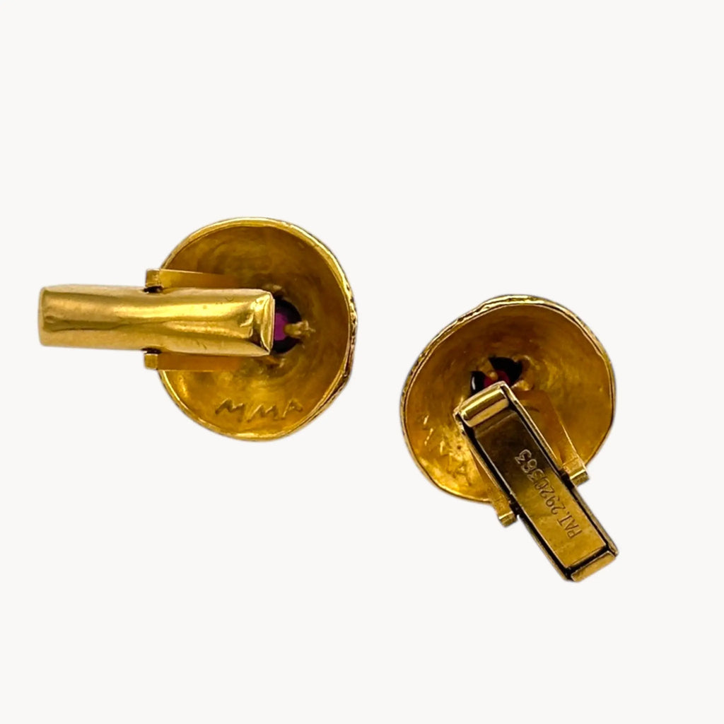Back view of Vintage MMA gold embossed cufflinks with cabochon centers displayed on white background.