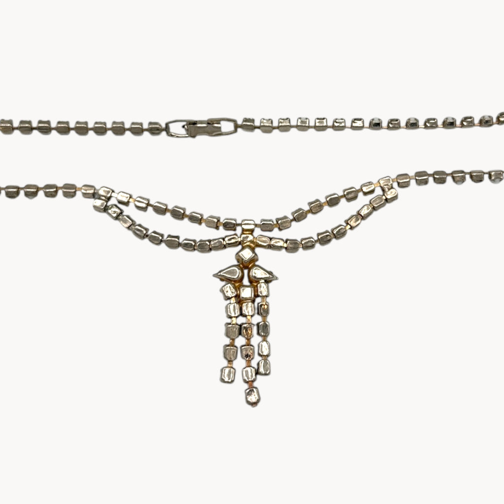 Back view of Vintage mid-century rhinestone and milk glass draped necklace with pendant drop.