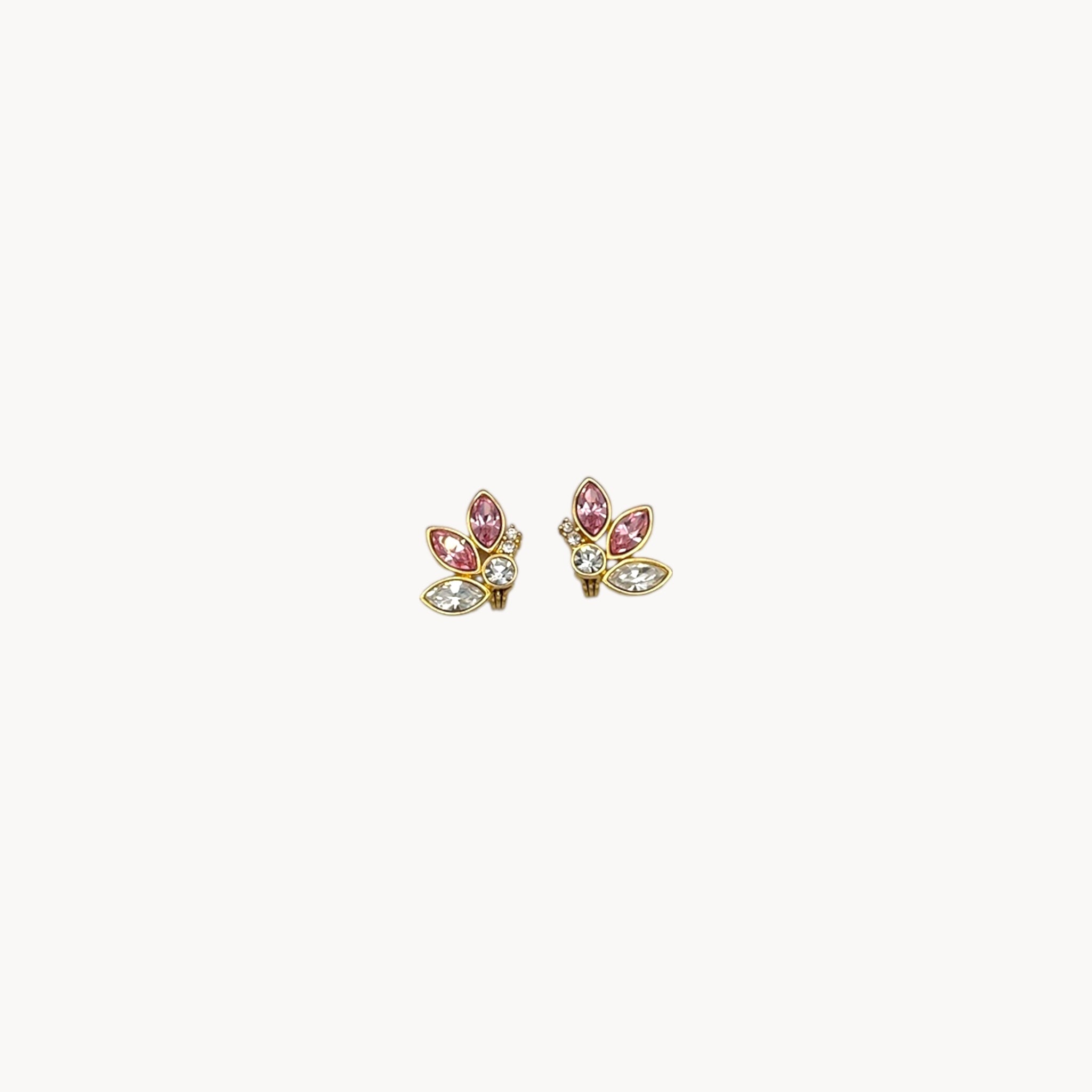 Monet gold-tone clip-on earrings with pink and clear marquise rhinestones on white background.
