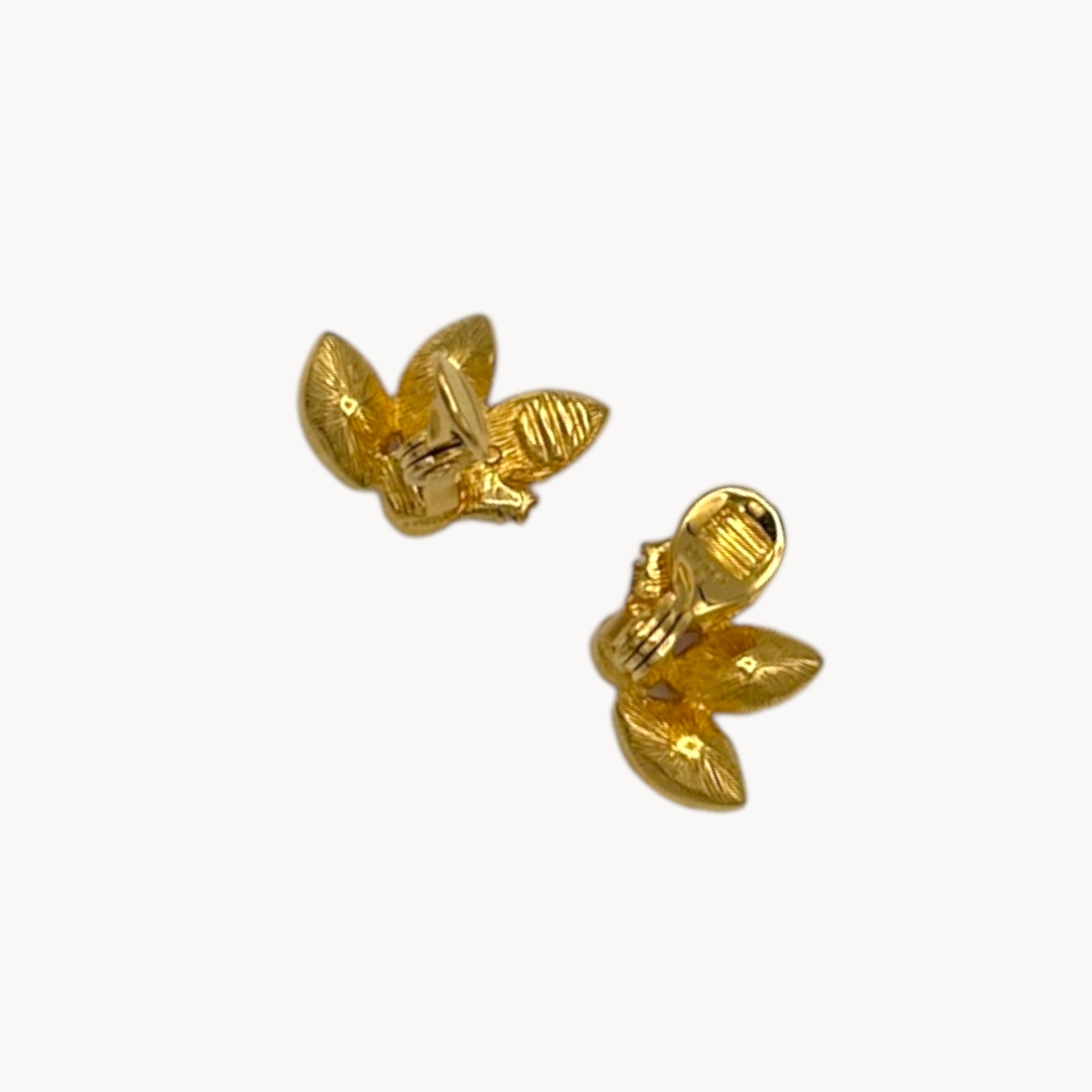 Back view of Monet gold-tone clip-on earrings with pink and clear marquise rhinestones on white background.