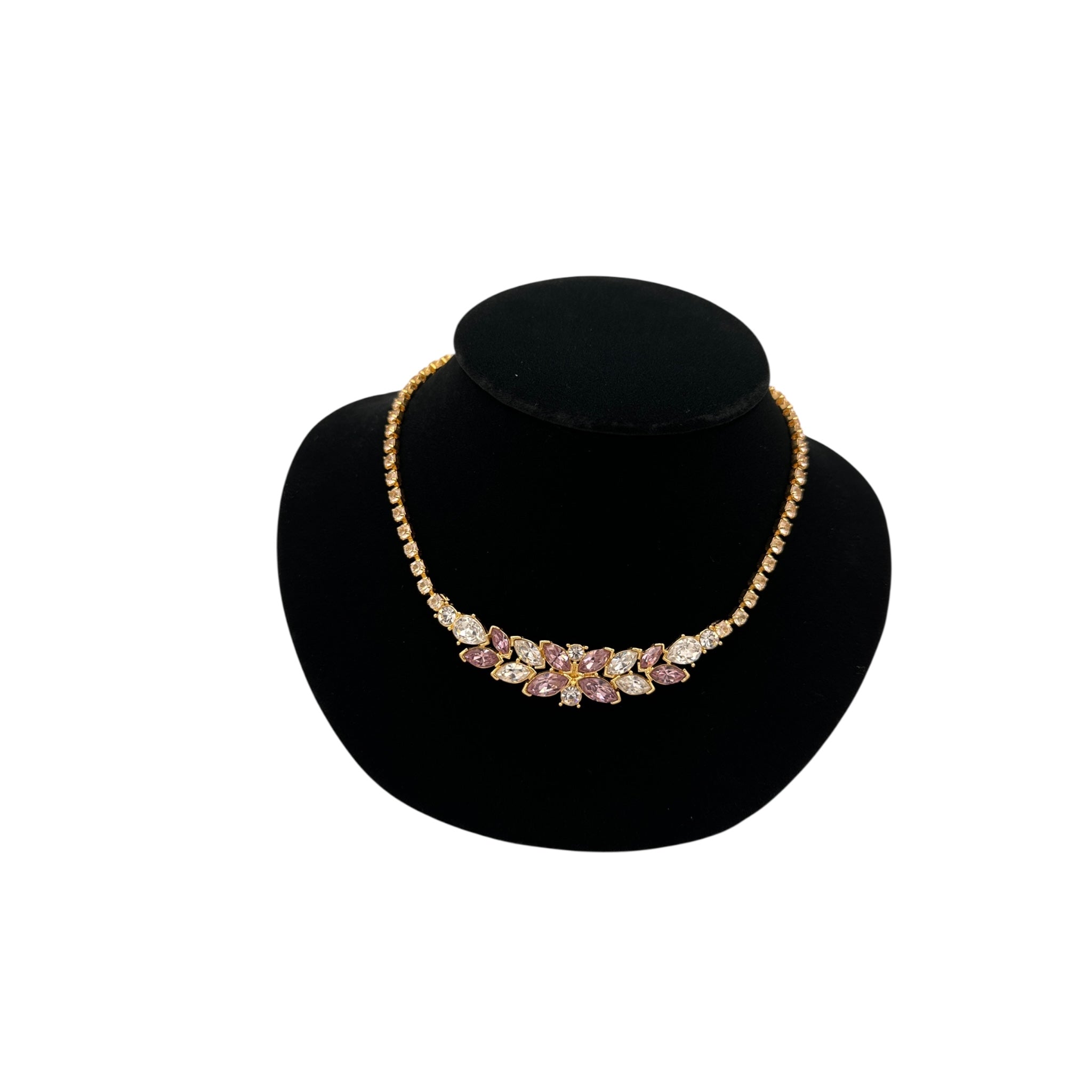 Close up view of Monet vintage pink and clear rhinestone floral necklace on gold-tone chain, romantic bridal jewelry.