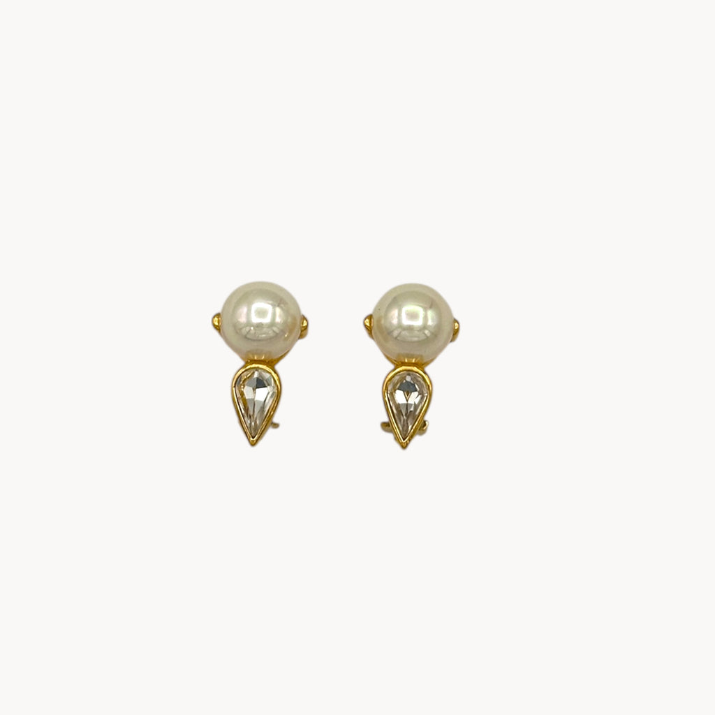 Close up view Nina Ricci vintage faux pearl and crystal teardrop clip-on earrings, 1980s bridal jewelry.