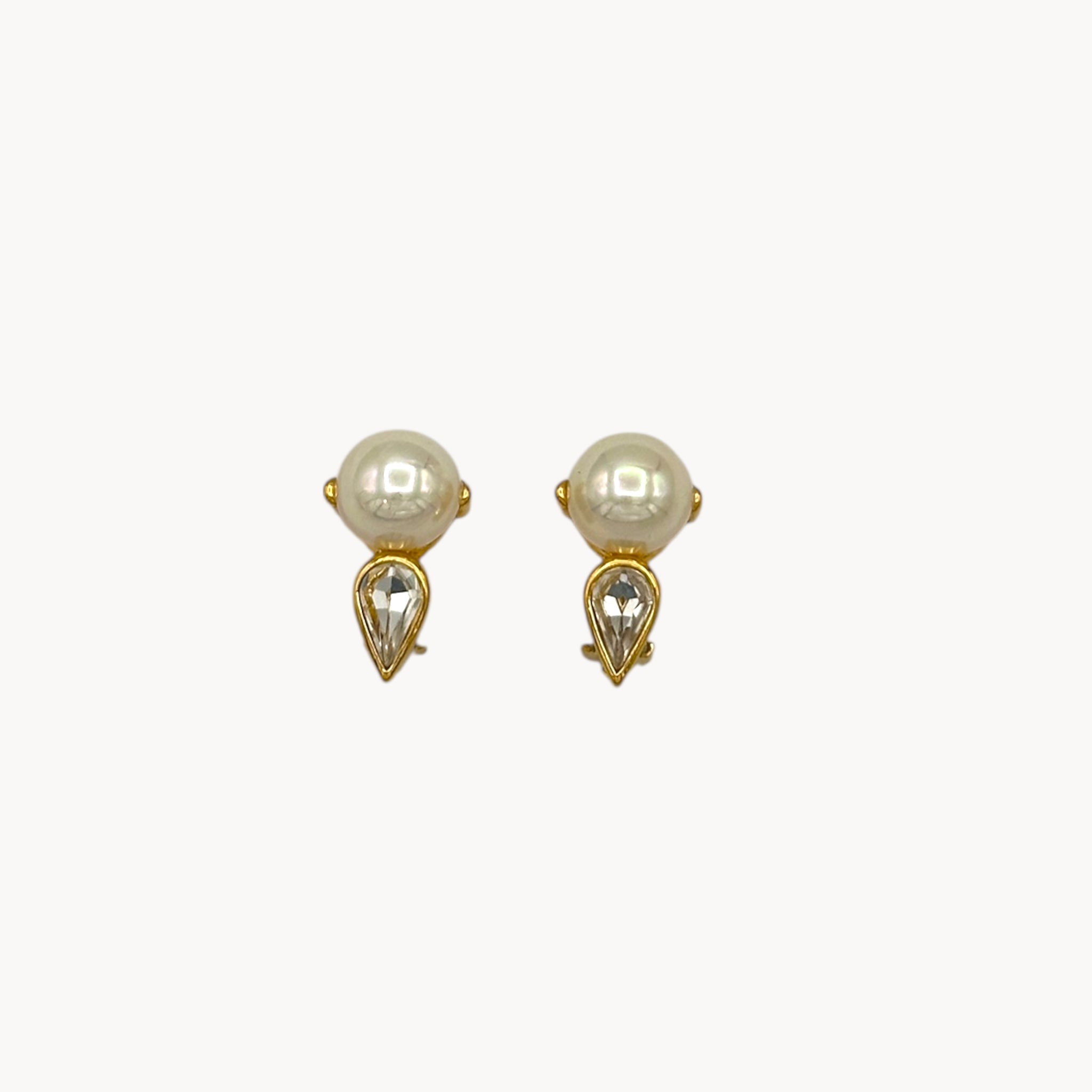 Close up view Nina Ricci vintage faux pearl and crystal teardrop clip-on earrings, 1980s bridal jewelry.