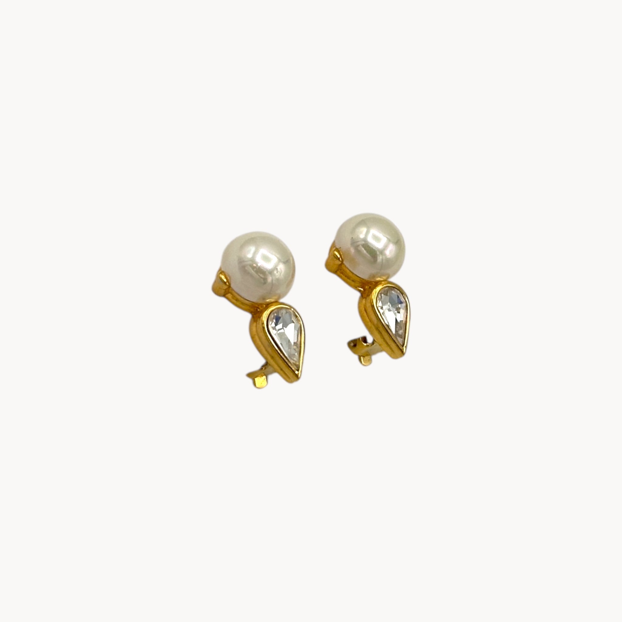 Side view of Nina Ricci vintage faux pearl and crystal teardrop clip-on earrings, 1980s bridal jewelry.