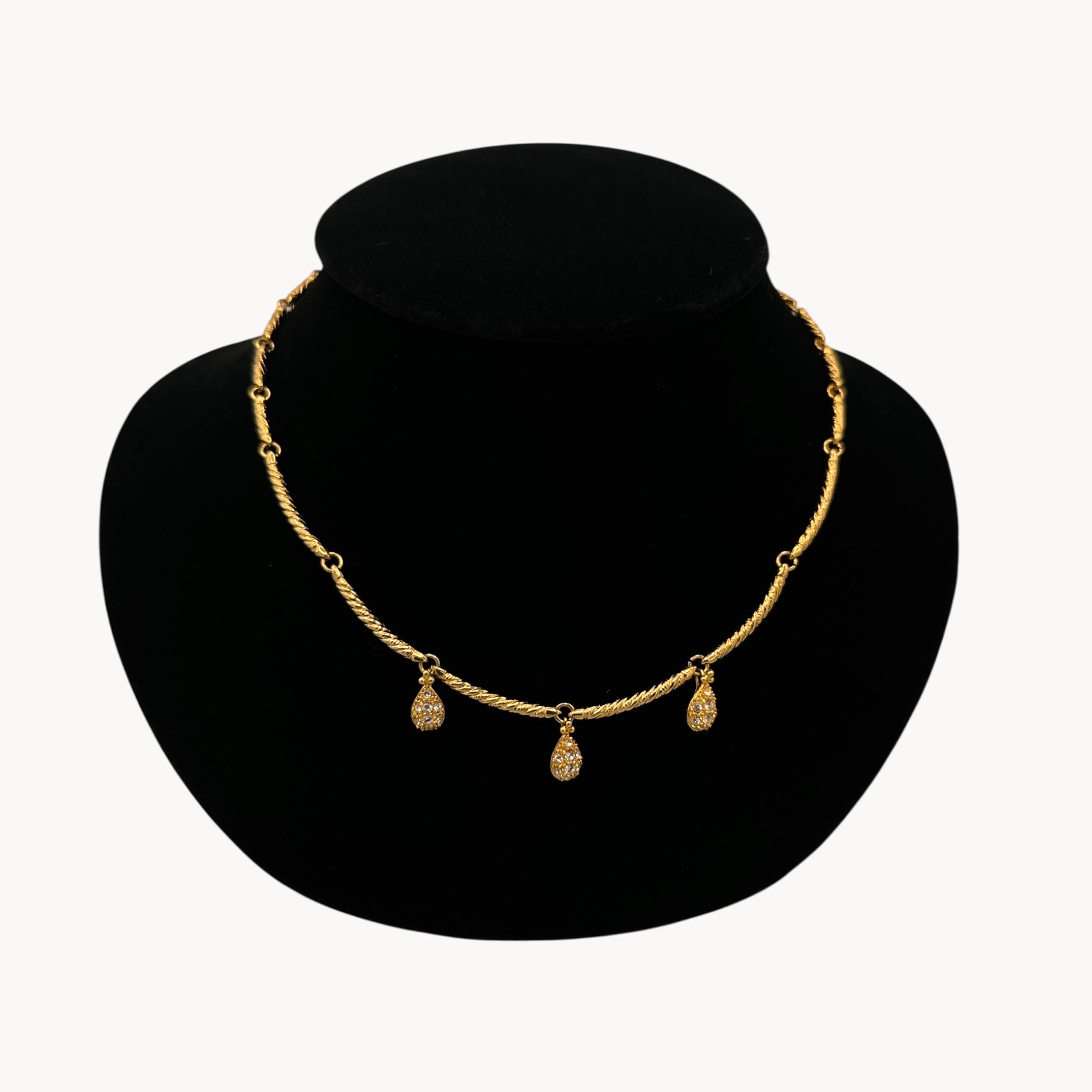 Close up view Nolan Miller gold adjustable necklace with removable rhinestone teardrop dangles, vintage bridal jewelry.