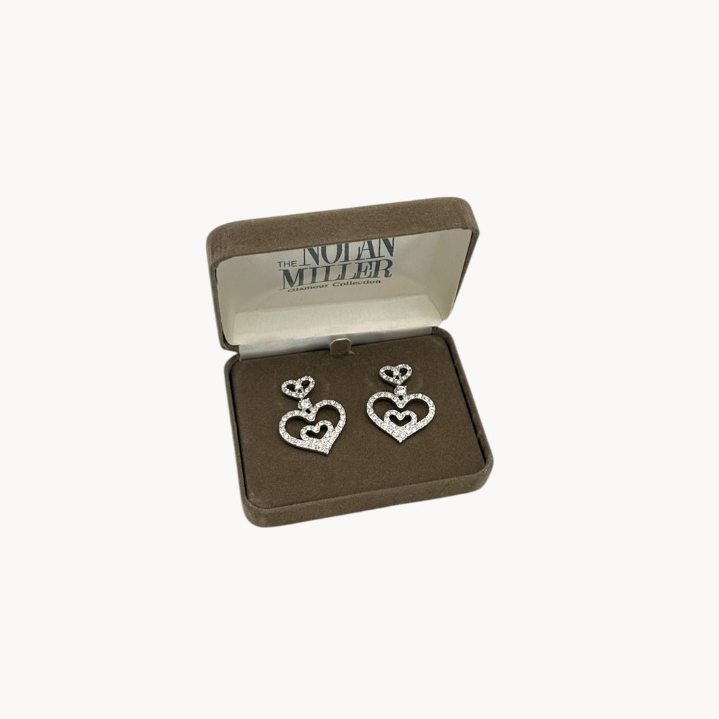 Vintage Nolan Miller rhinestone heart dangle pierced earrings with double open-heart design in orginal box.