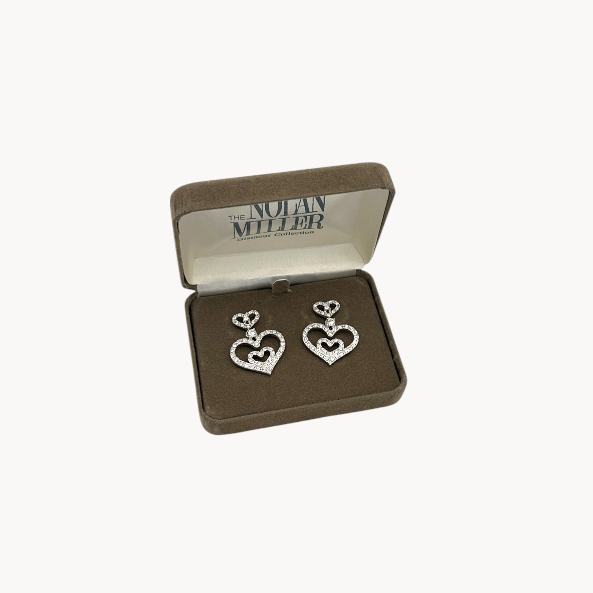 Vintage Nolan Miller rhinestone heart dangle pierced earrings with double open-heart design in orginal box.