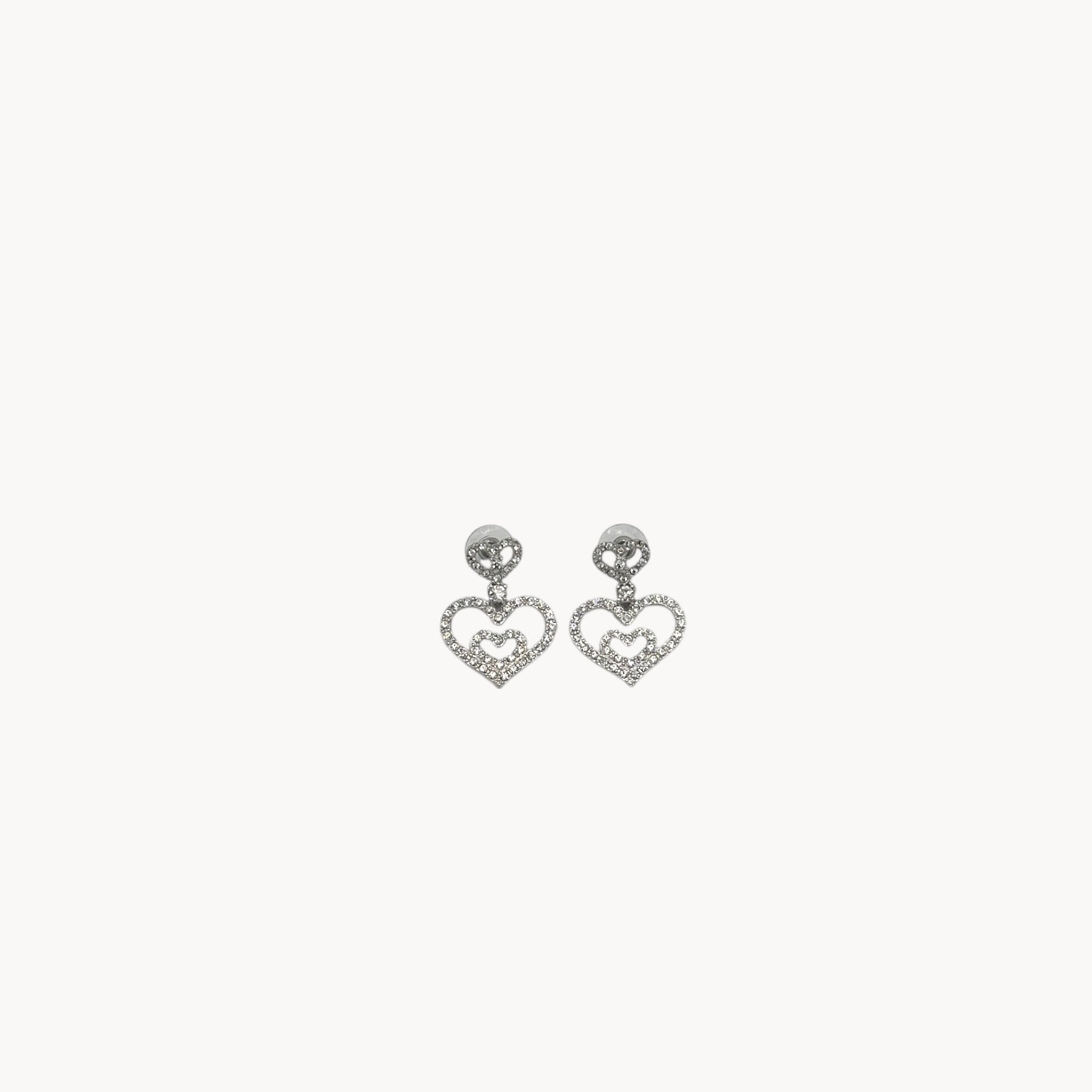 Vintage Nolan Miller rhinestone heart dangle pierced earrings with double open-heart design.