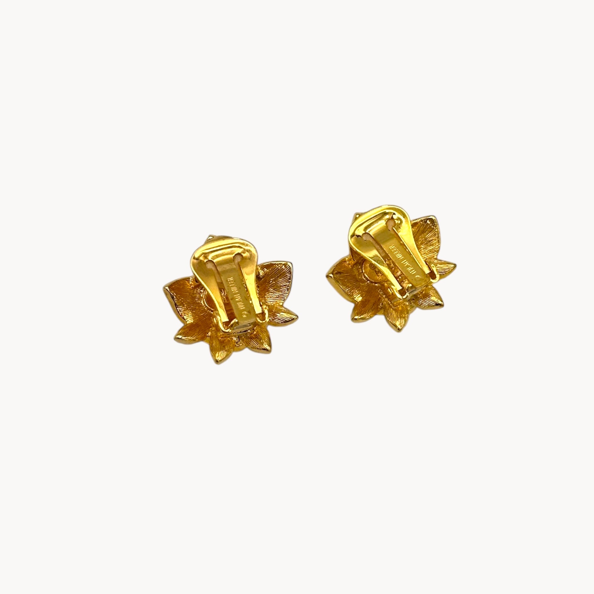 Back view of Nolan Miller vintage flower clip-on earrings with clear and amethyst rhinestones accents in gold-tone metal.