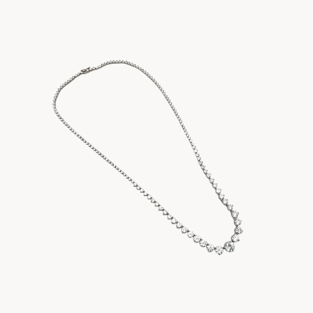 Sterling silver rhodium-plated graduated tennis necklace with round-cut stones on white background.