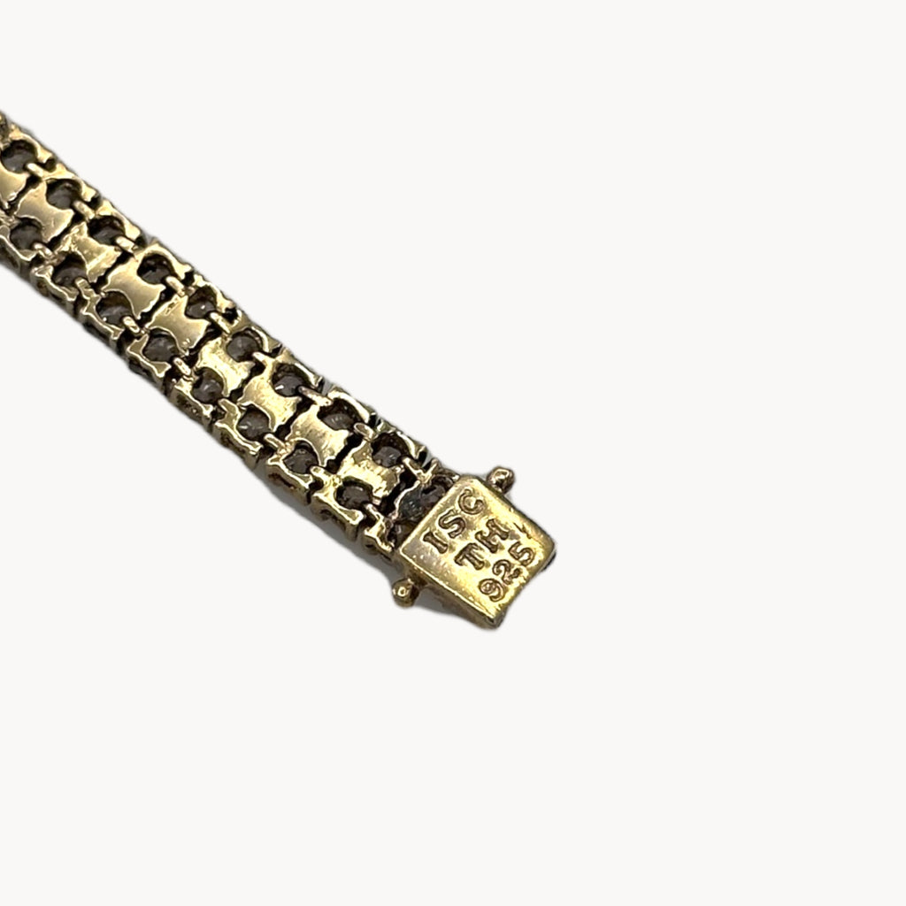 Close up of clasp of Sterling silver vermeil gold plated two row CZ tennis bracelet.