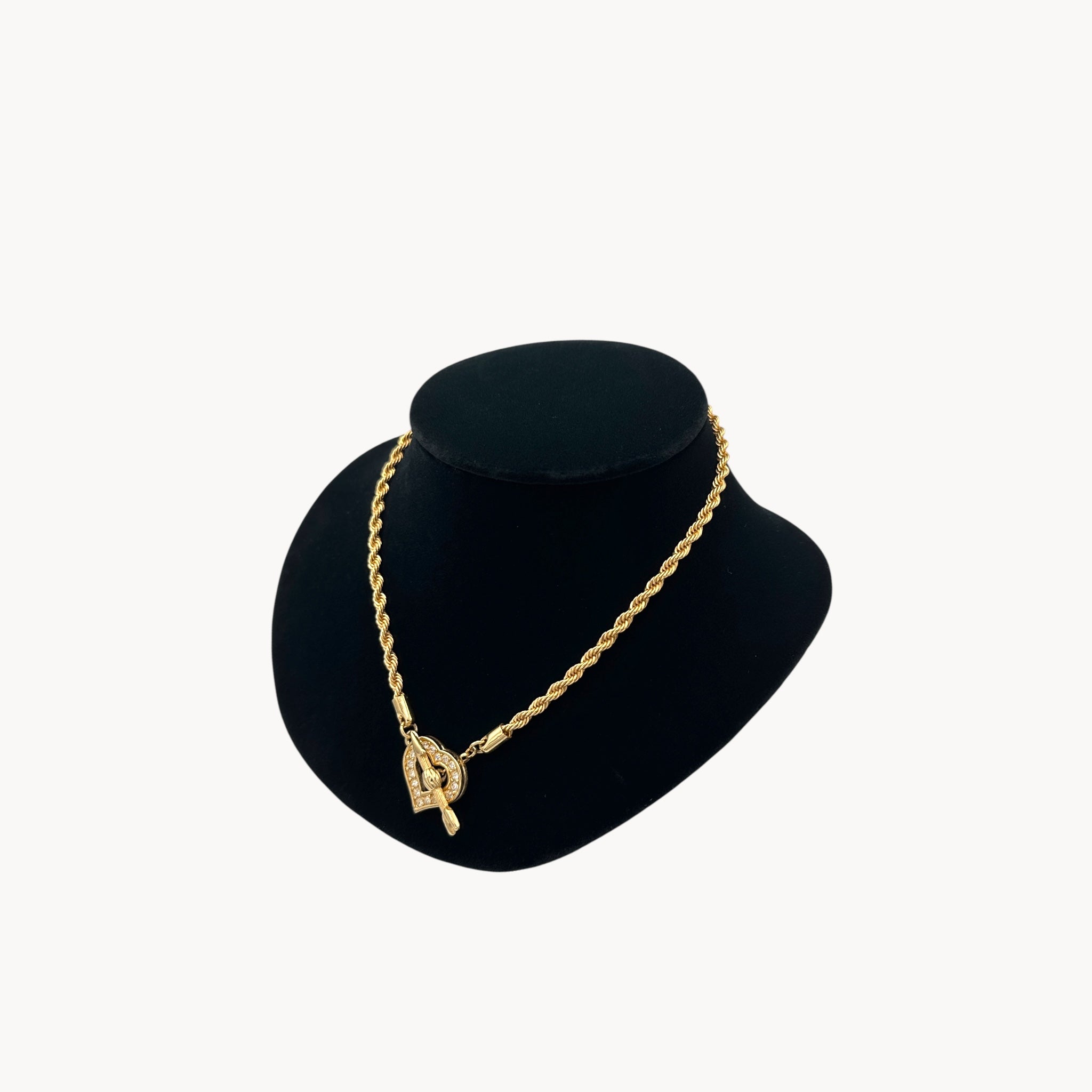 Side view of Swarovski gold rope chain necklace with pave heart toggle clasp.