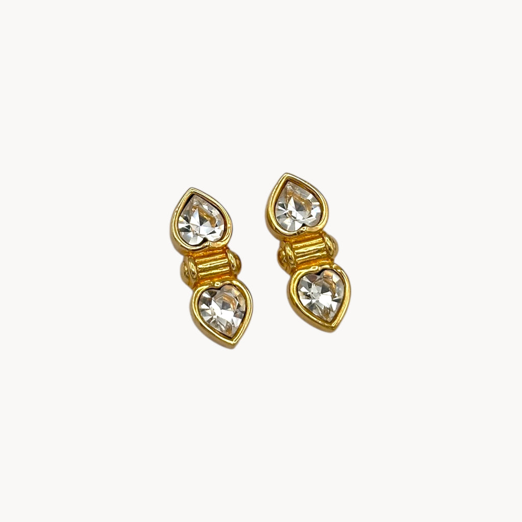 Close up view of Vintage Swarovski SAL clear double heart rhinestone pierced earrings.